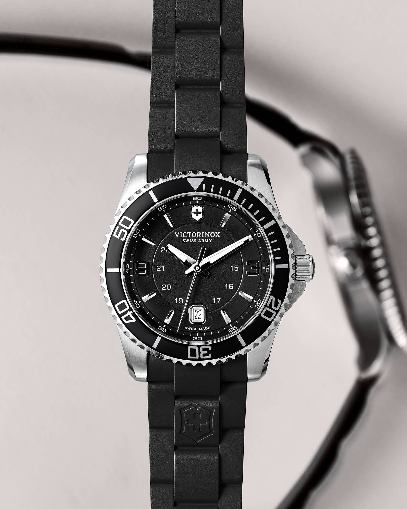 Victorinox Swiss Army watch with black dial and rubber strap, luxury timepiece.