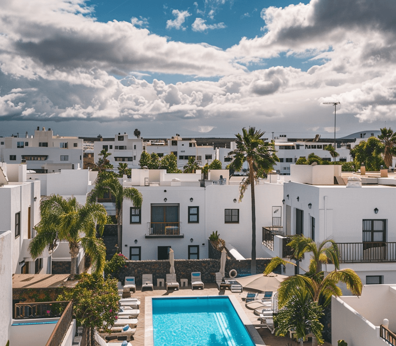 Mediterranean style residential complex with pool and palm trees