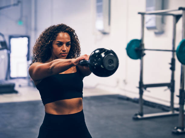 an image of a woman holding a kettlebell