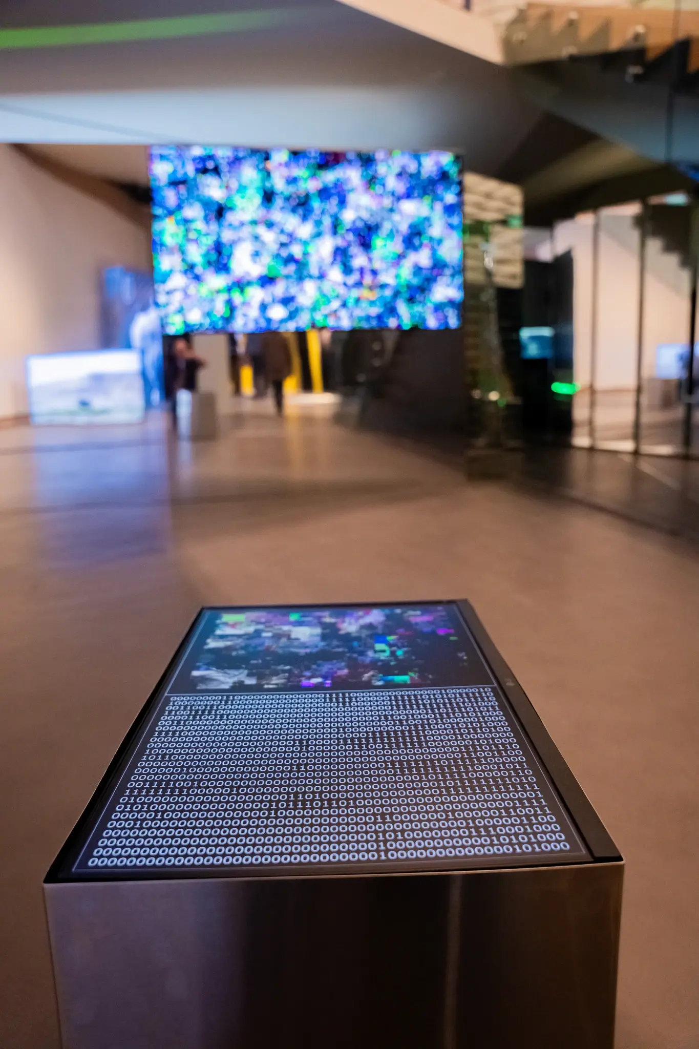 Digital display with binary code and abstract art