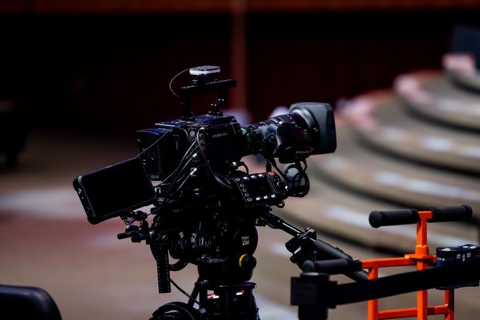 A professional media production set with high-end cameras and lighting