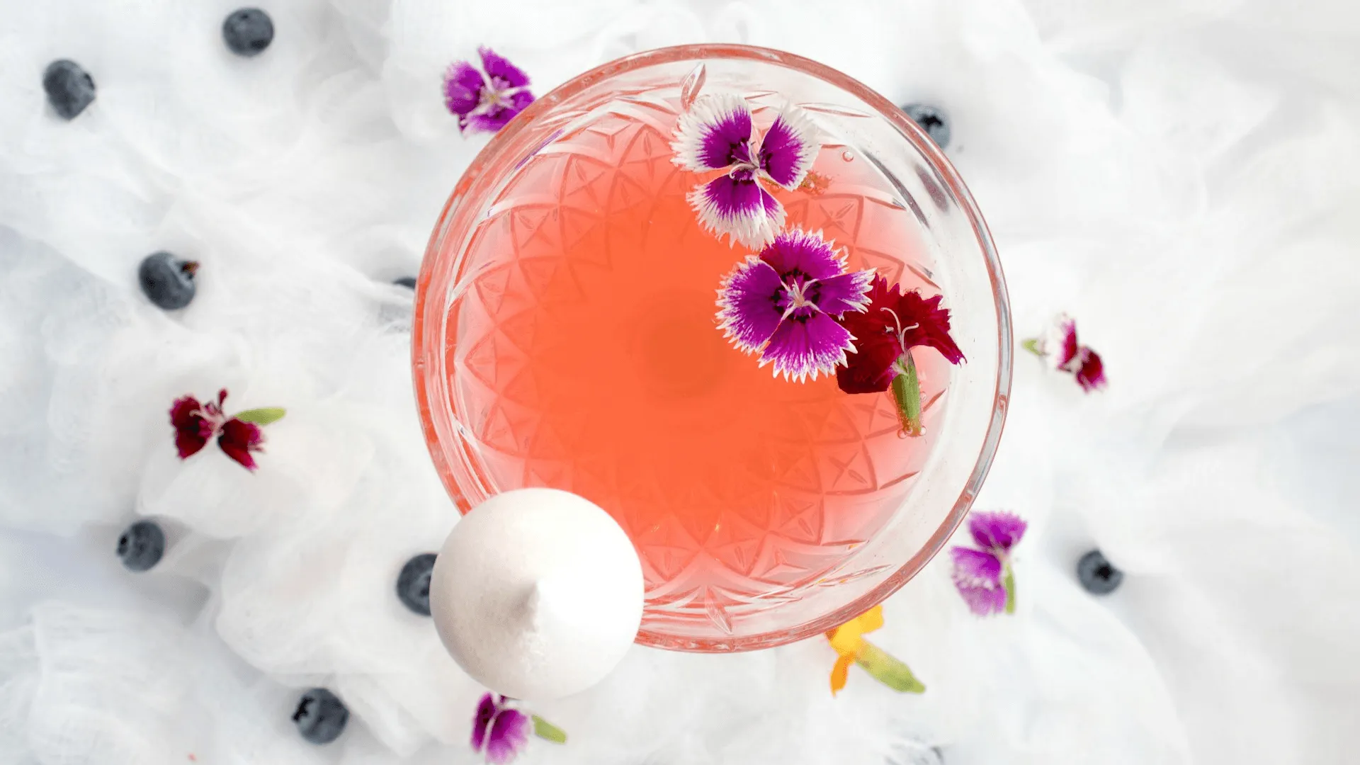 A shot looking down on a glass holding a summery looking cocktail