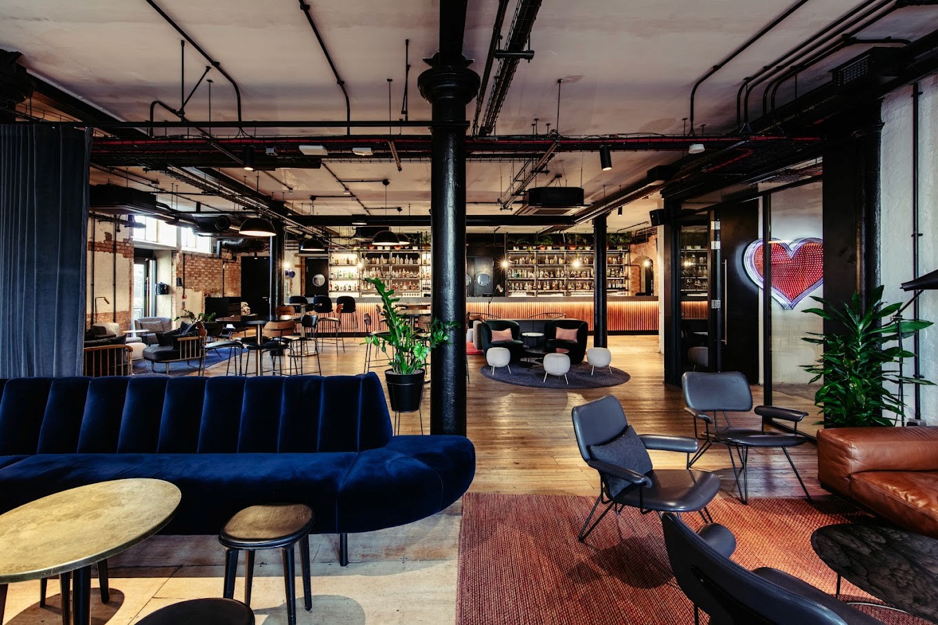 Stylish lounge area with modern seating and a bar, ideal for casual meetings.