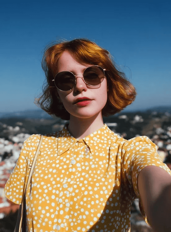 Redhead woman in yellow dress.