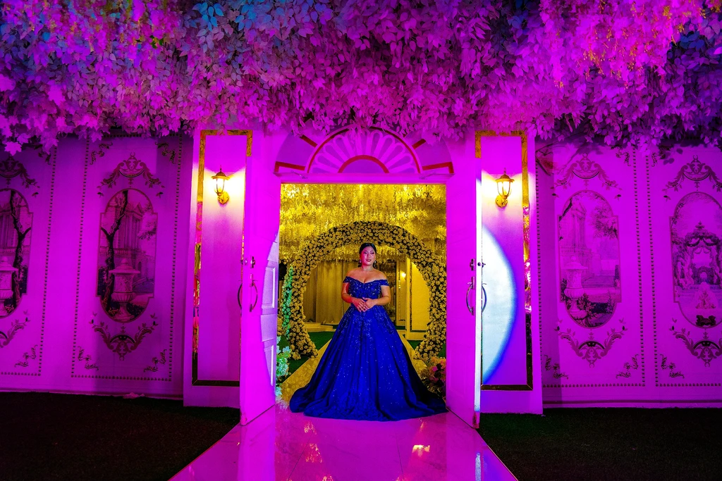 Debutante in blue at the magenta-lit doors of Celestia Hall, Quezon City