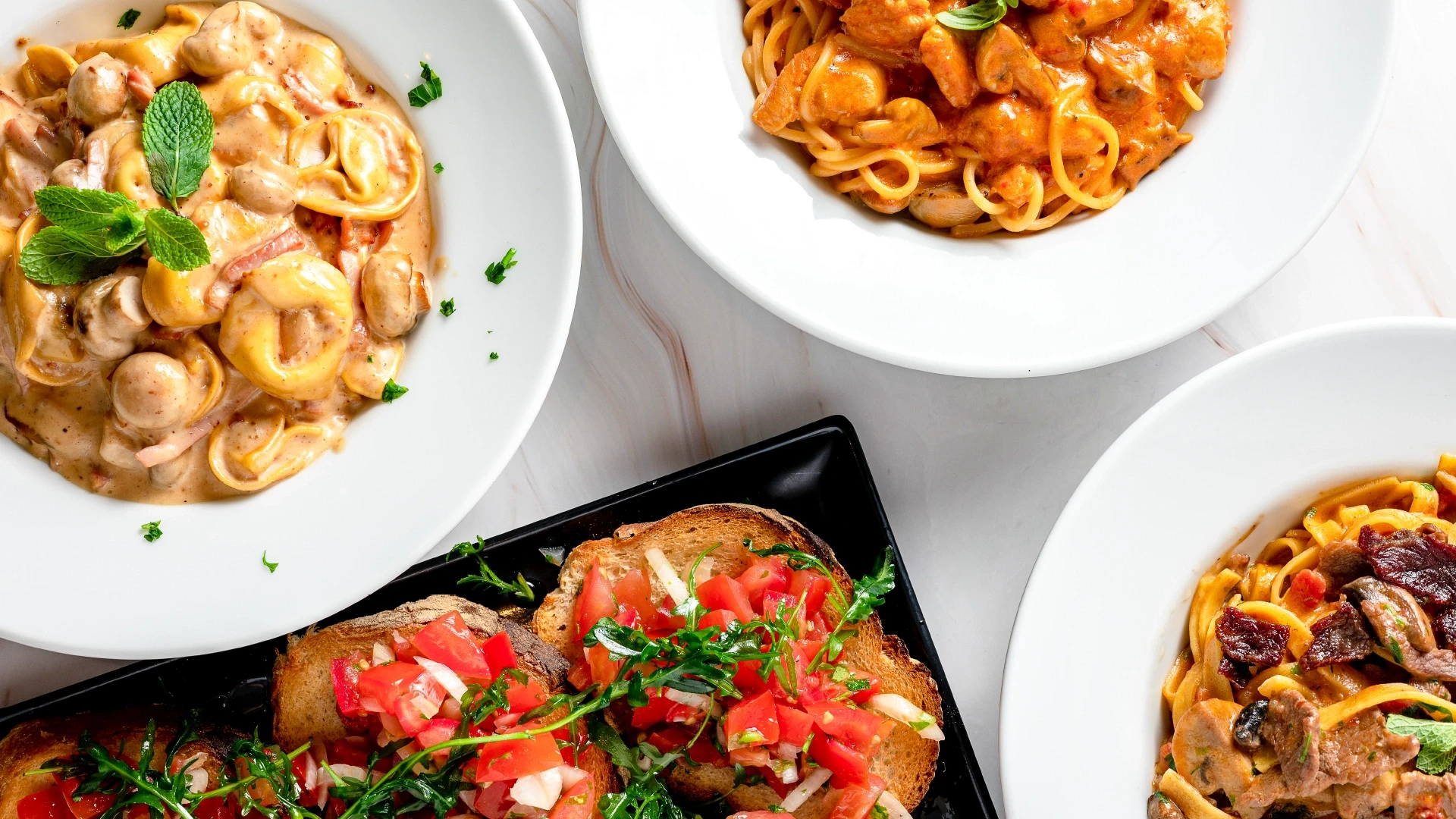 two glass of iced tea with some orange fruit around them