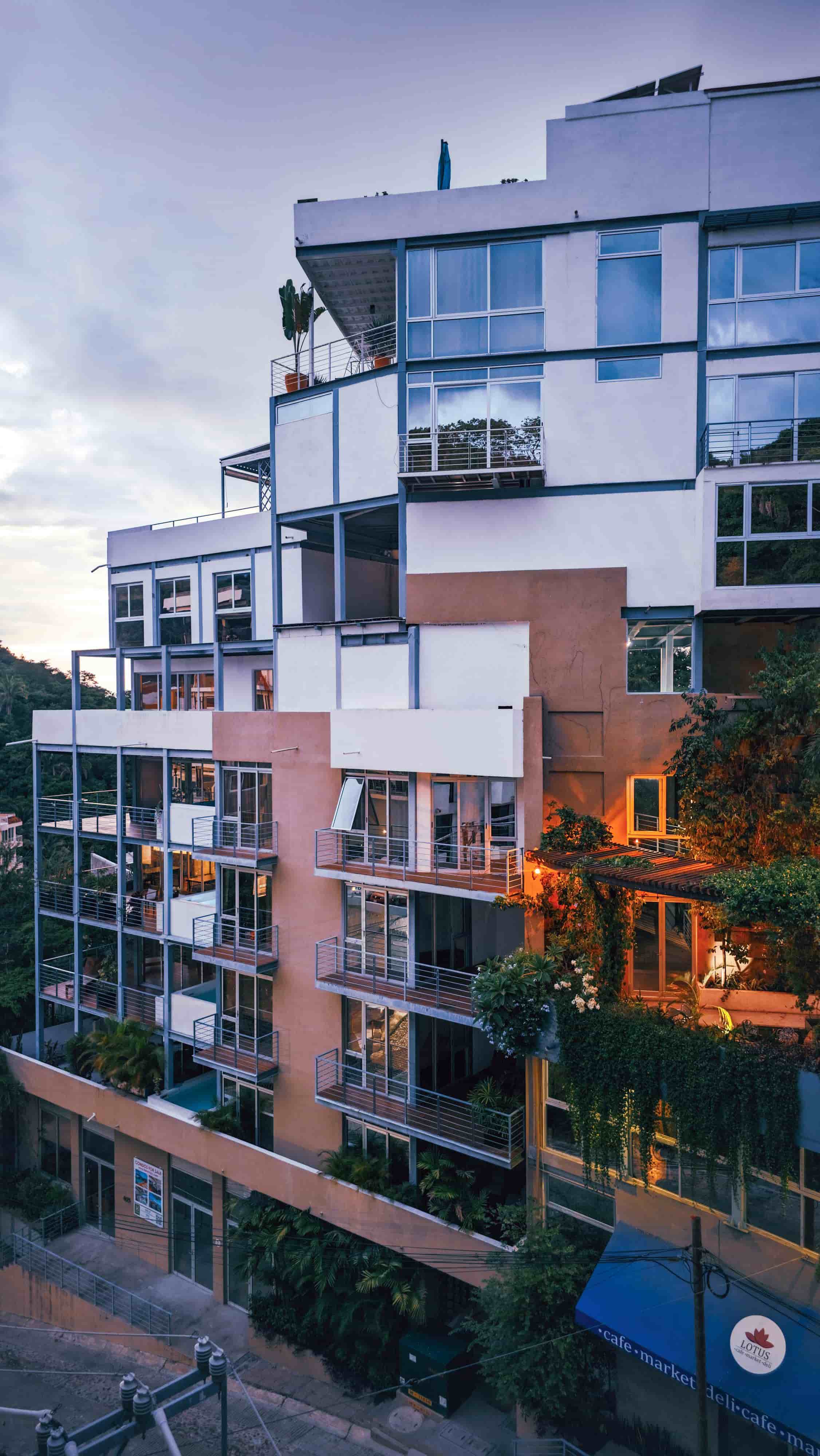 Contemporary multi-unit residential building with balconies at dusk