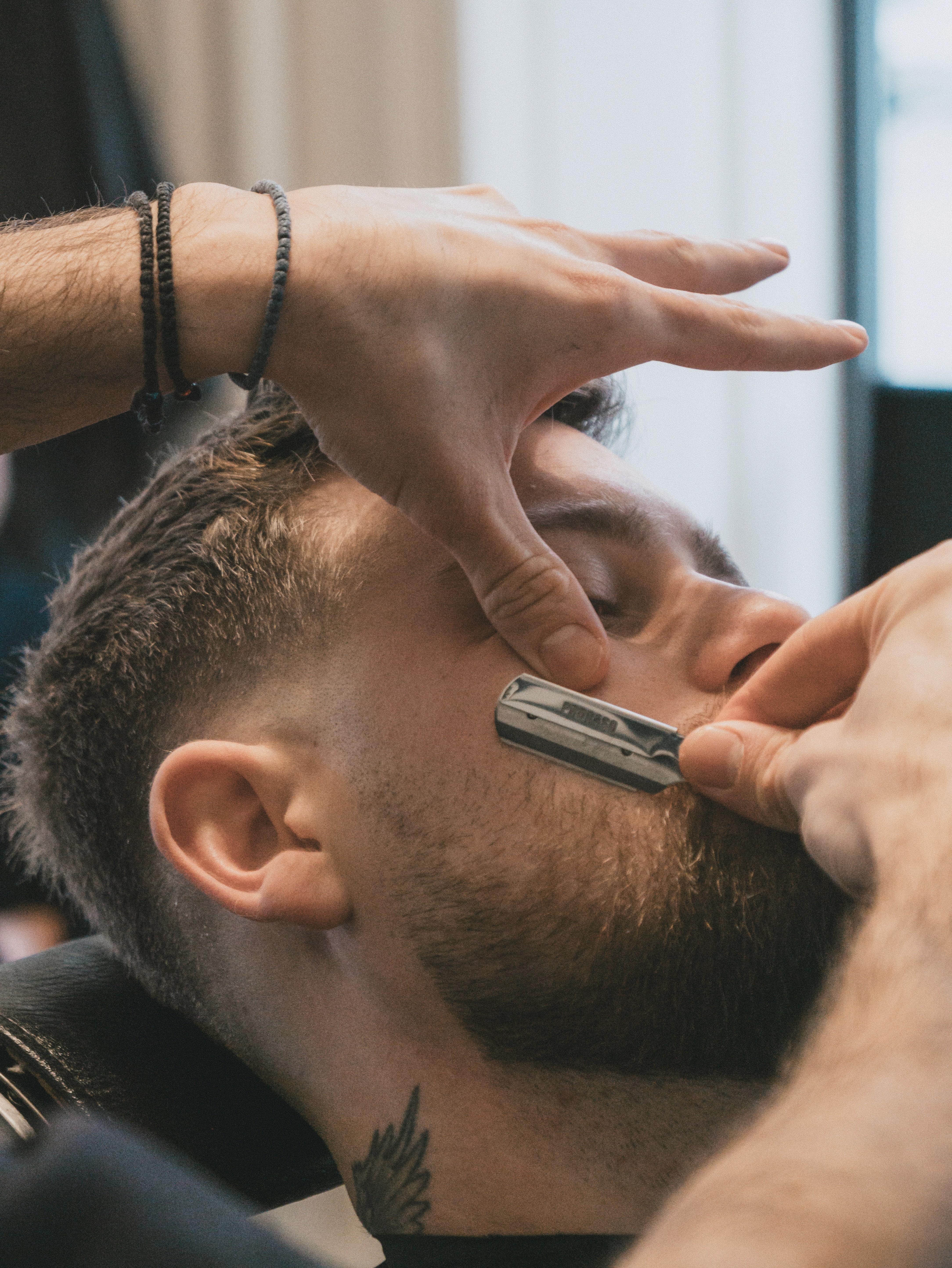 Clipper trimming the back of a man's hair