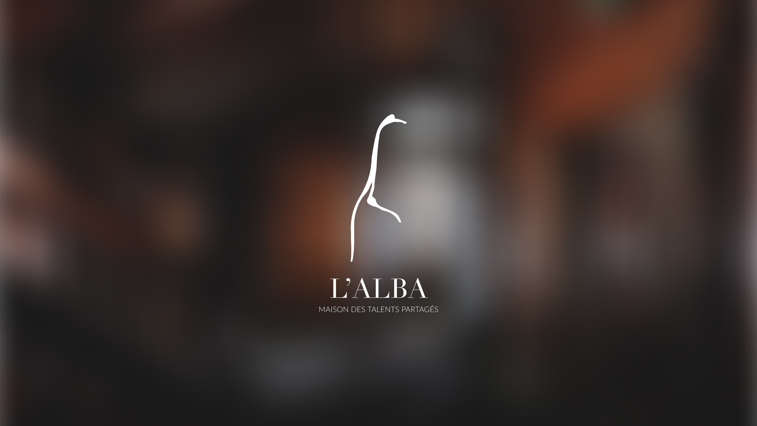 l'alba logo on blurry background