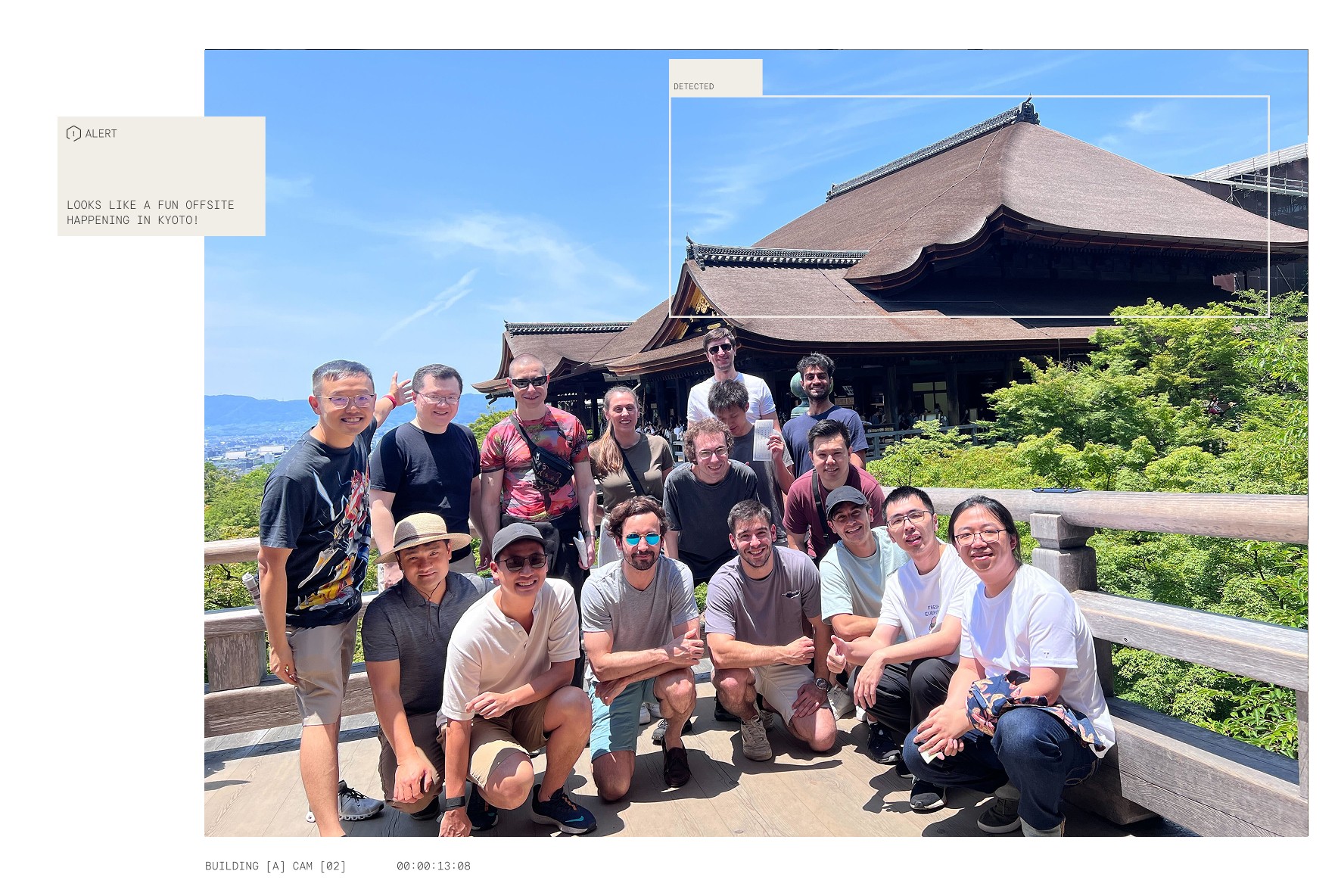 A group photo of the Reka team smiling together on a wooden balcony overlooking a traditional Japanese temple and lush greenery.