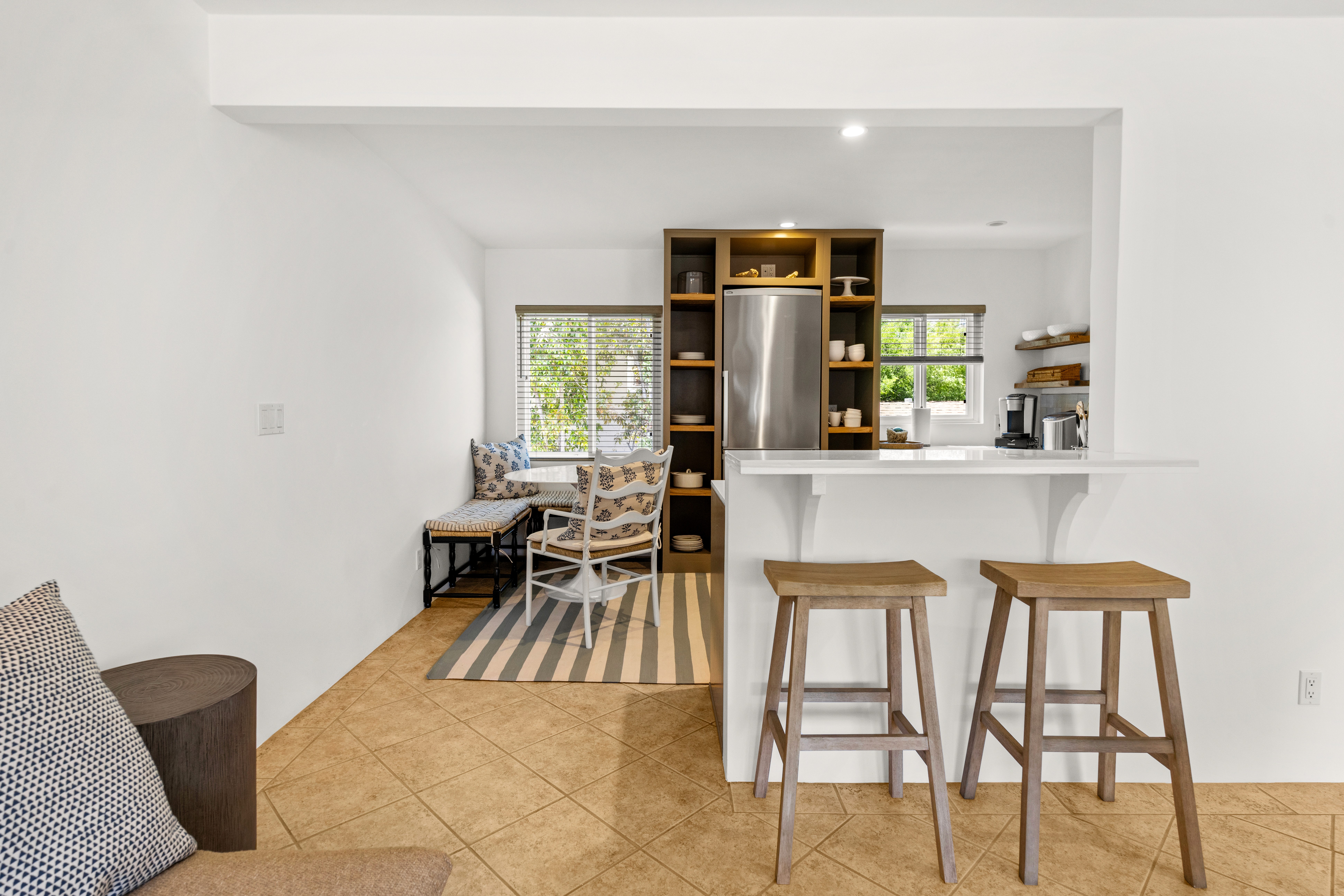 A bright, open living area offering seamless flow from the kitchen to the lounging space, ideal for gathering and unwinding.