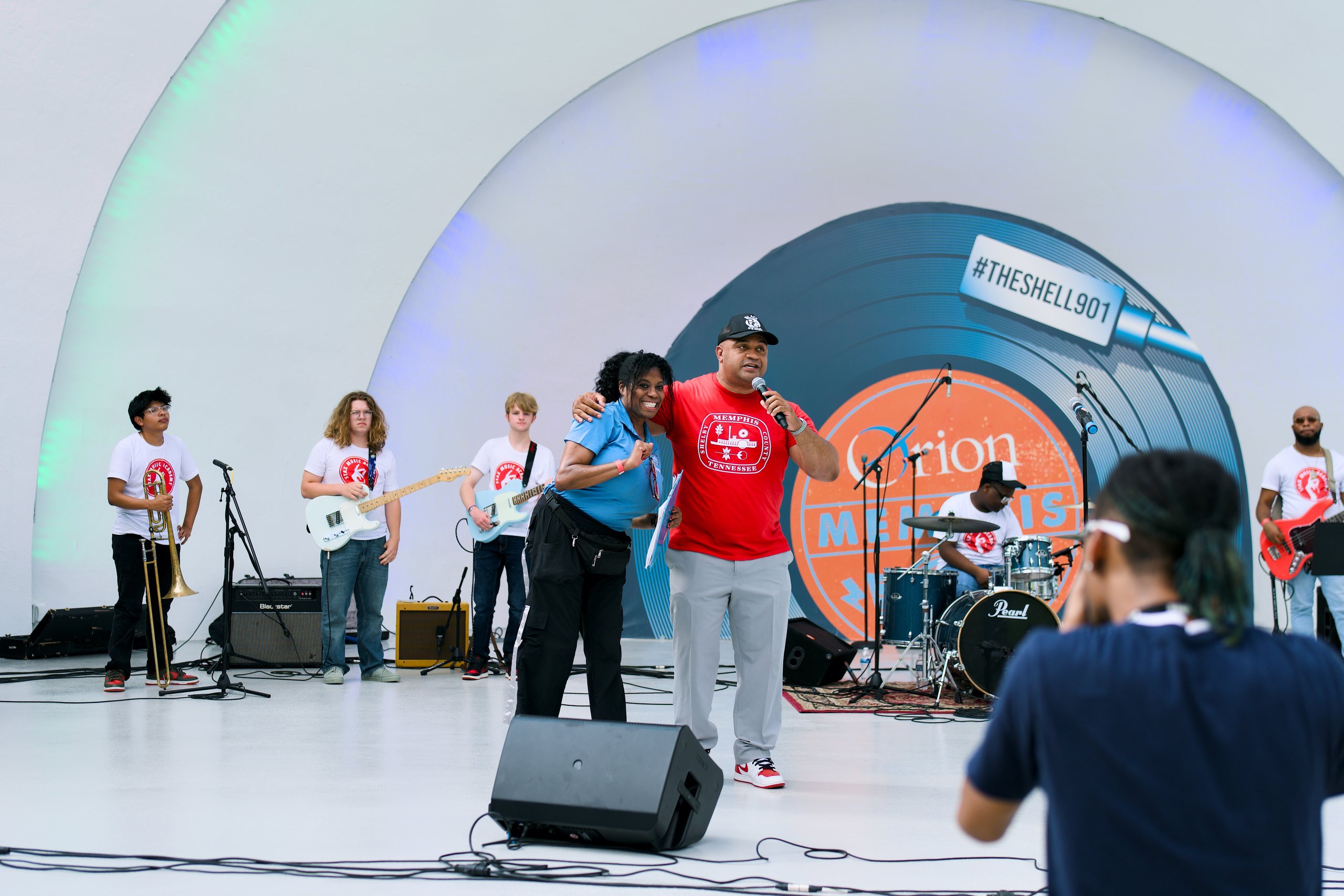Teen band plays as two hosts share the mic on the Overton Park Shell stage
