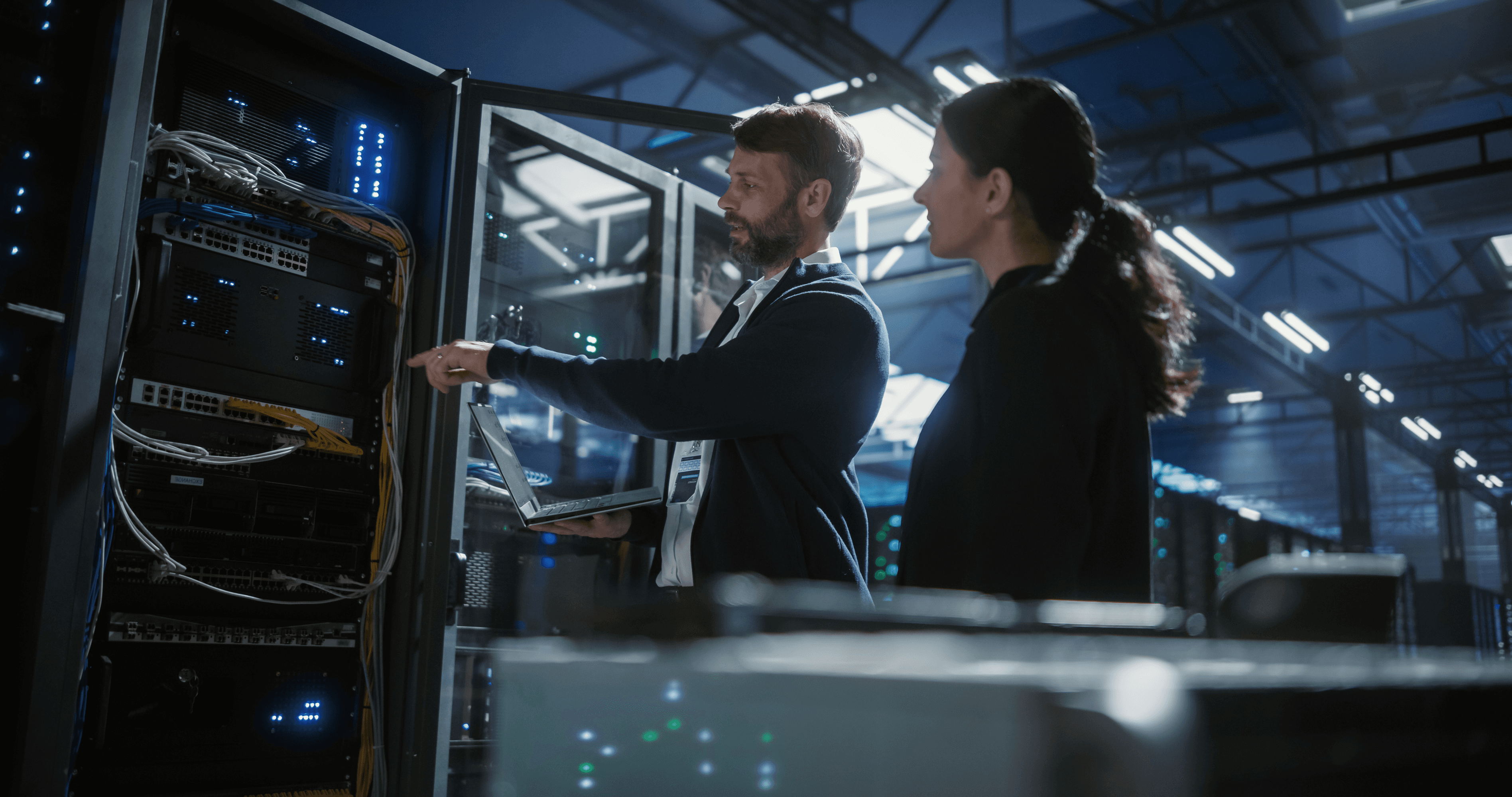 Auditor and data centre representative review technical security controls during an information security audit.