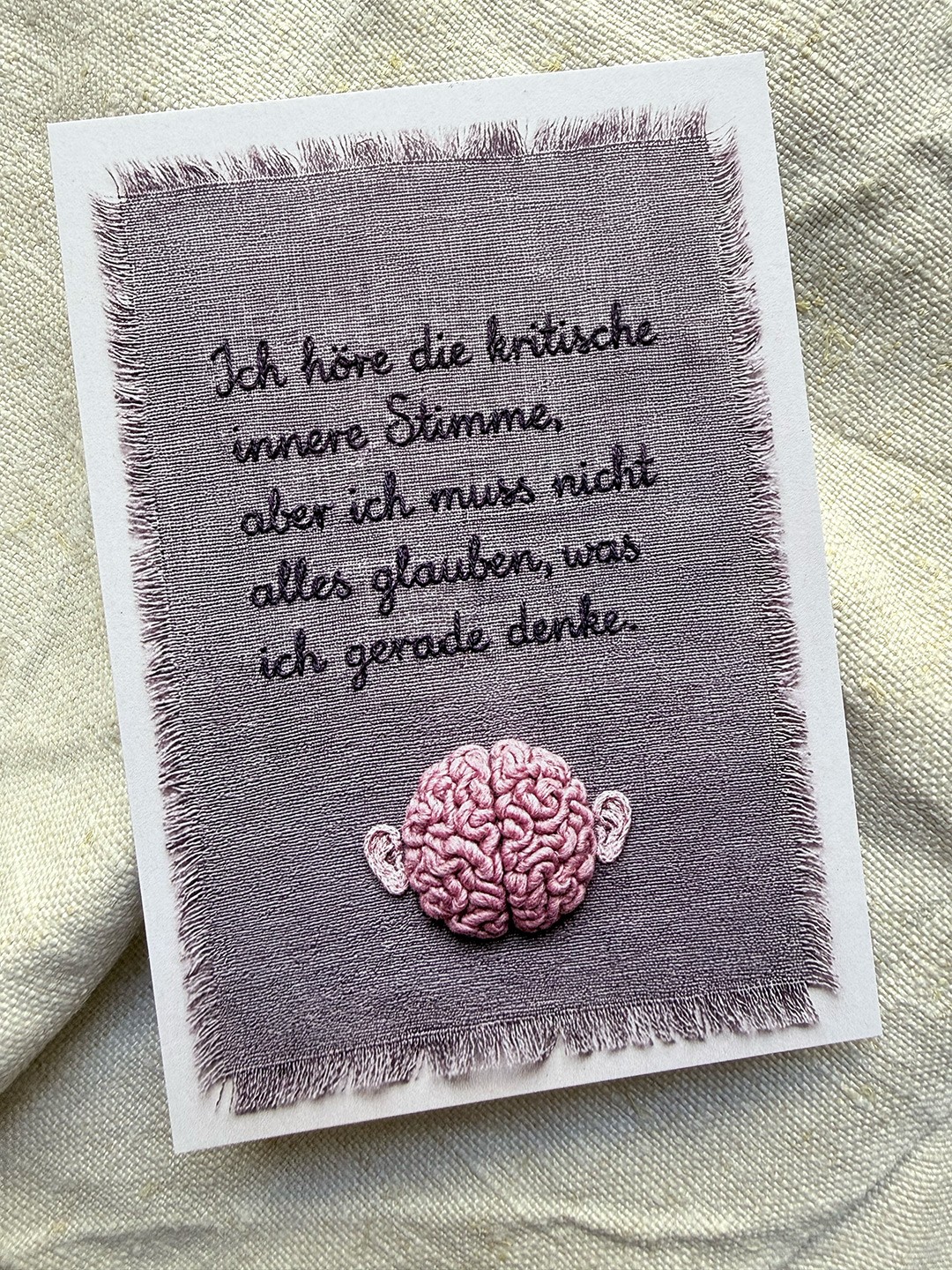 A Card with a embroidered Text