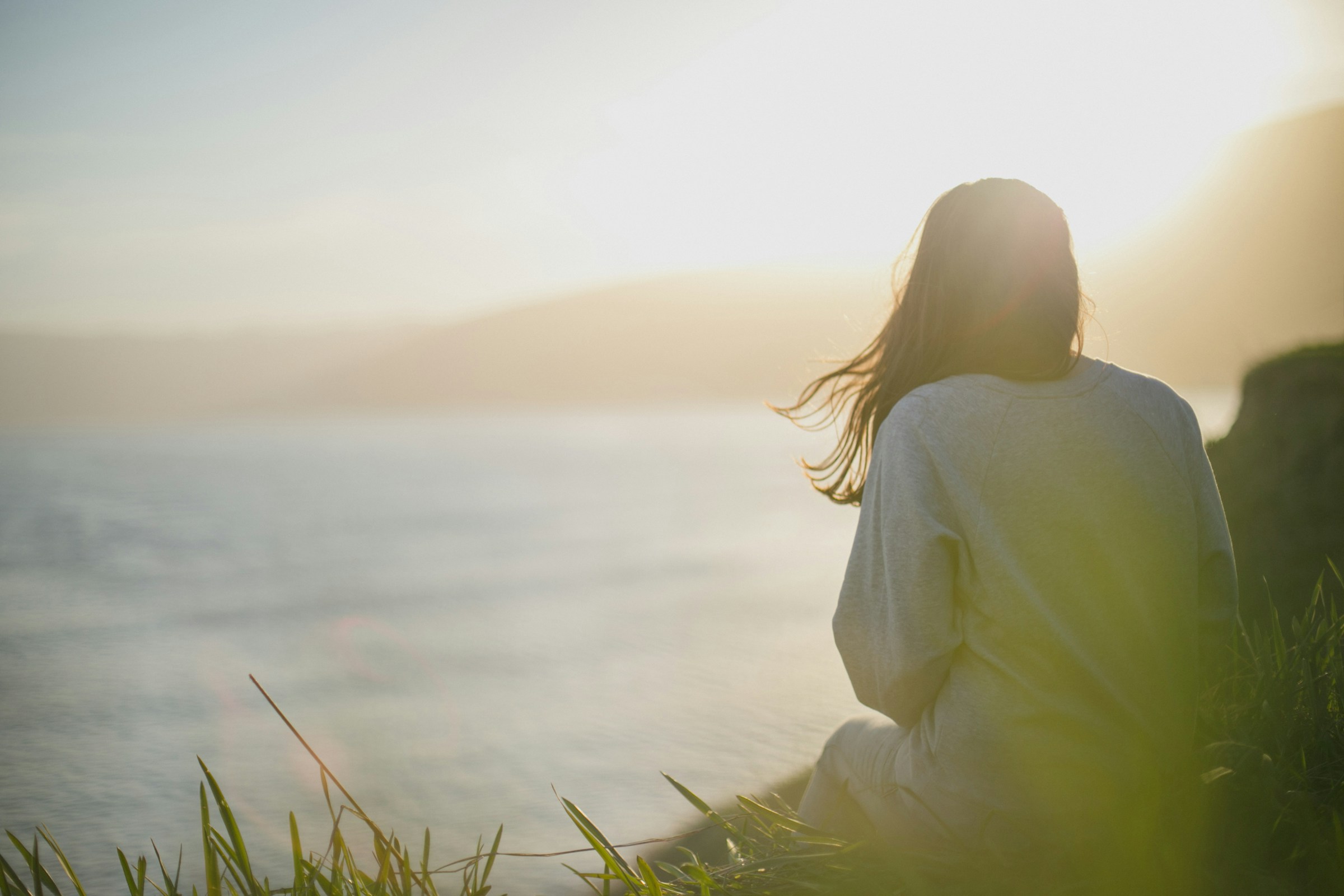 woman sitting outdoor - Can You Get Vitamin D in the Shade