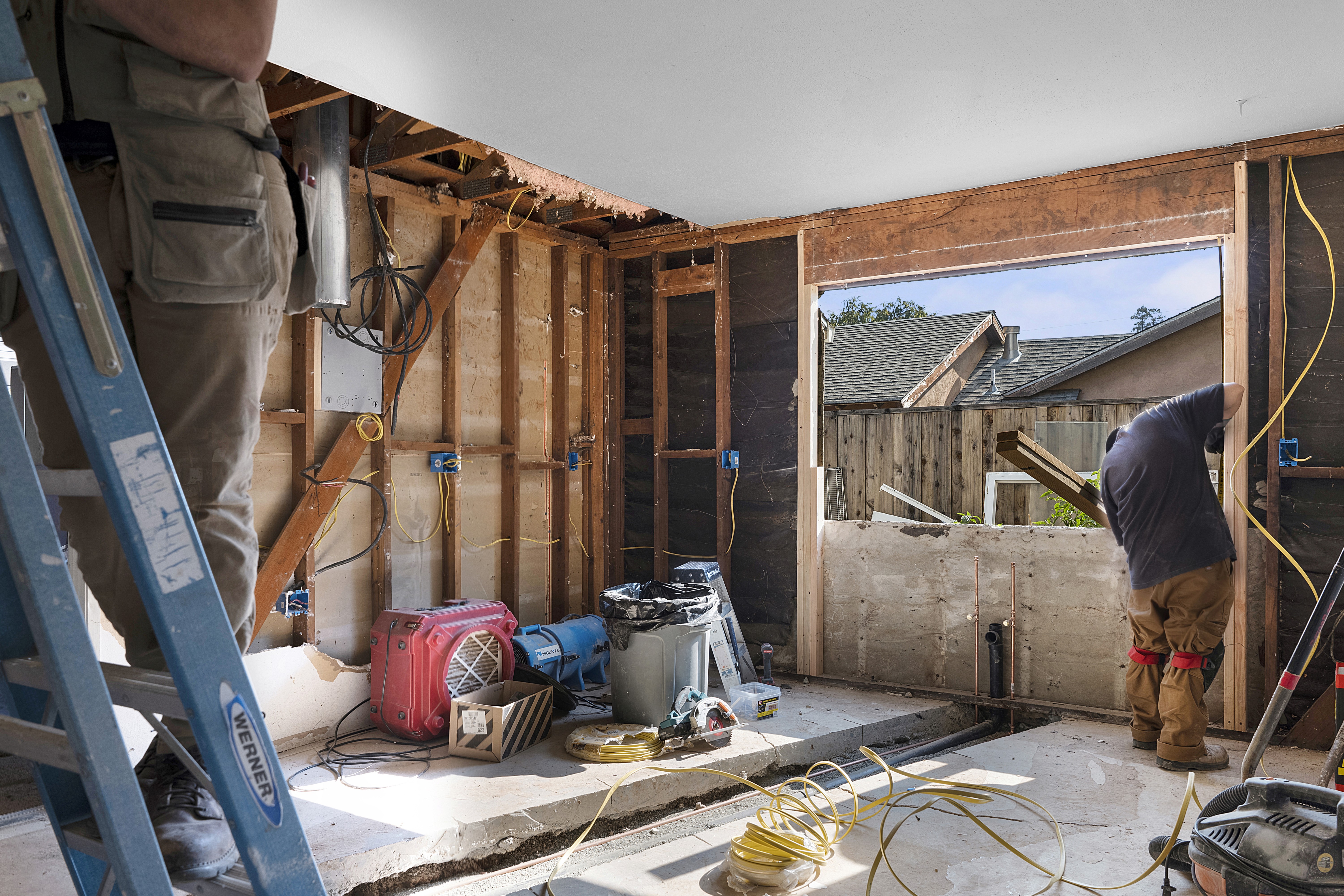 “Aerial view of a modern commercial building with brick exterior and large glass corner windows”