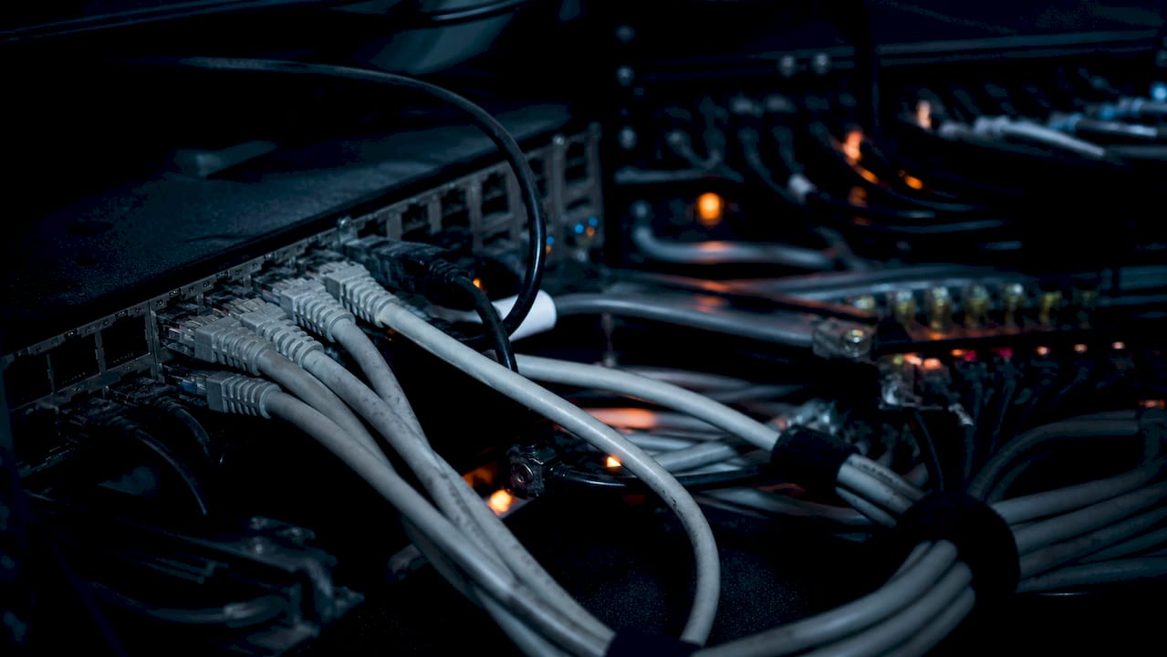 Network hardware with cables in dark room