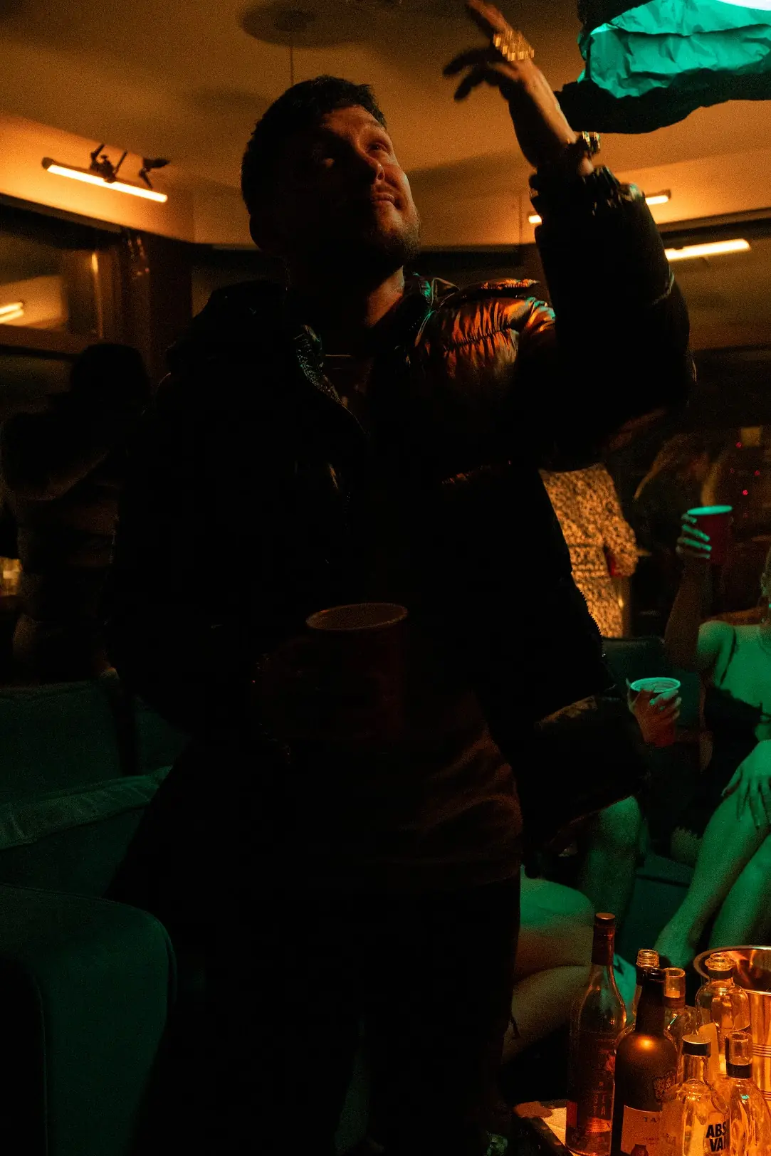 A man staring and pointing towars the ceiling in a studio