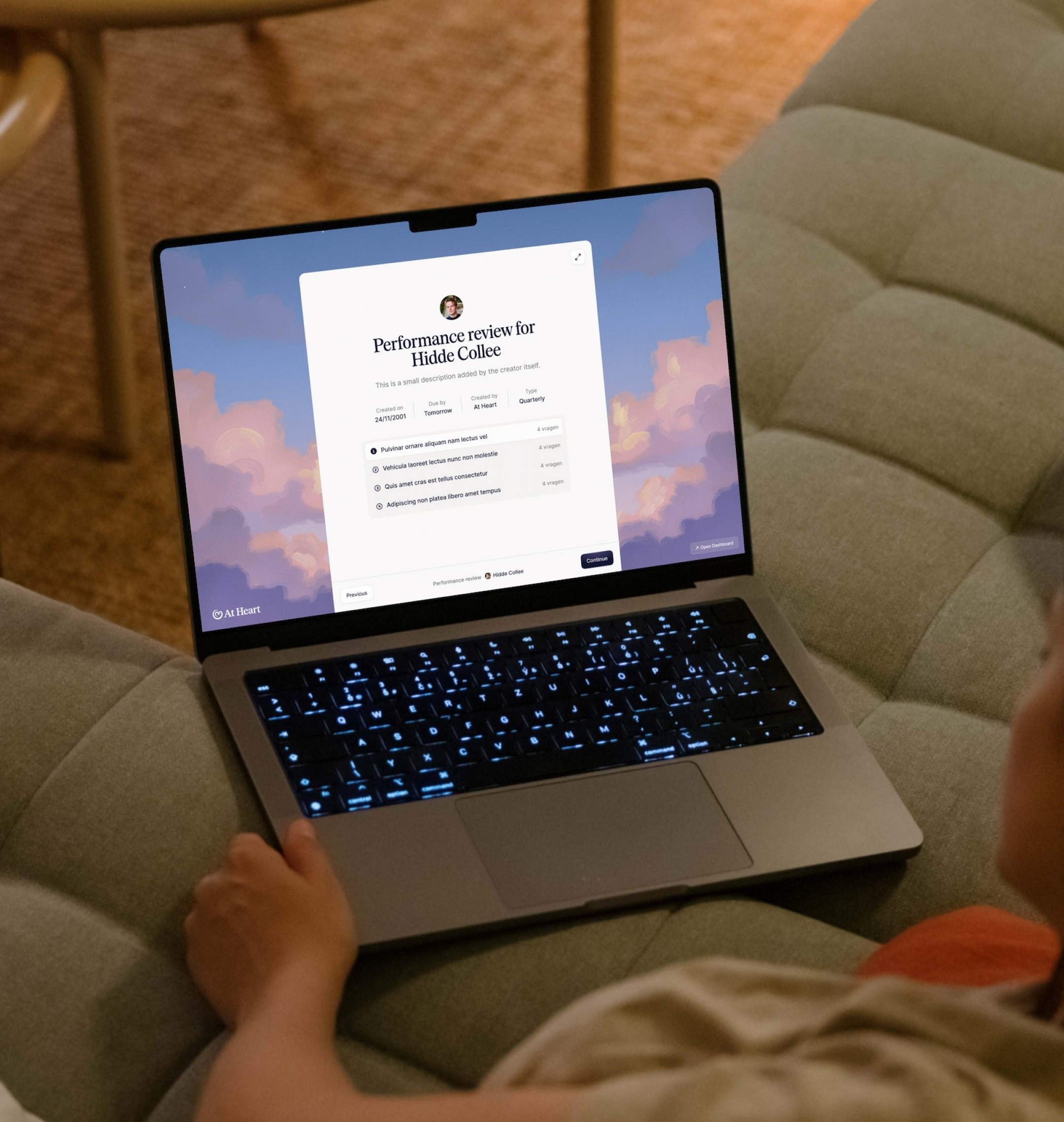 Child is sitting on a couch with a laptop