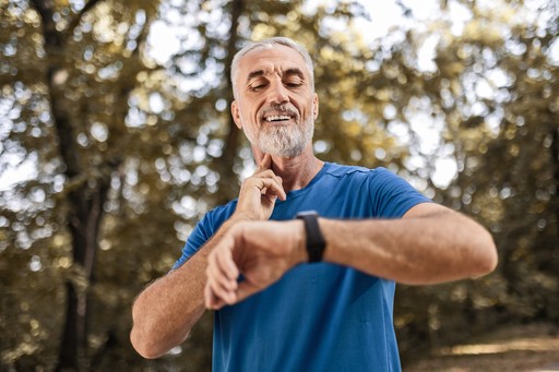 man measuring his pulse