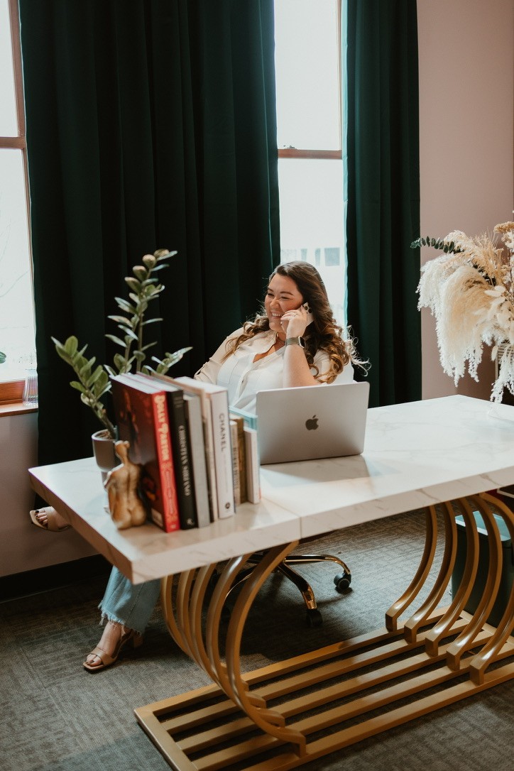a person sitting at a table with a laptop