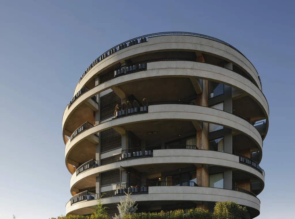 Round modern building with curved balconies and clean architectural lines