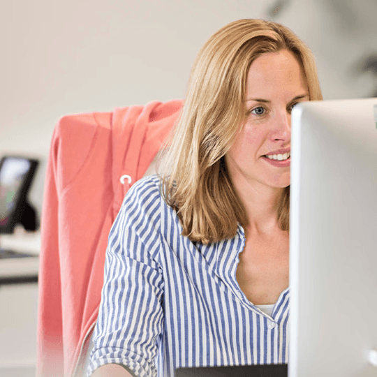 Female working at a large computer screen