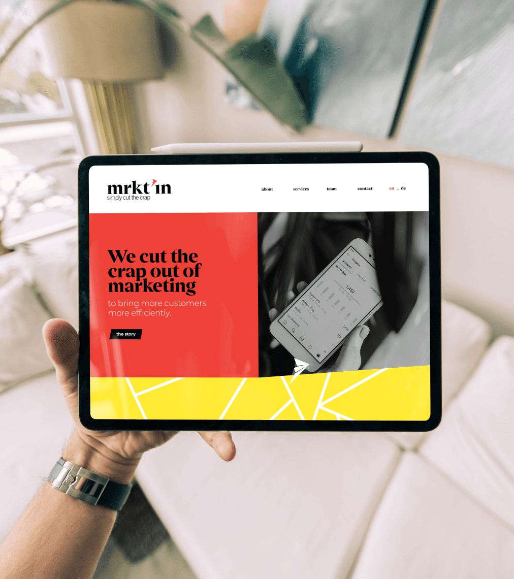 Man holding ipad with website on screen.