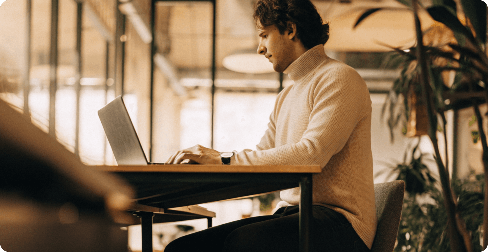 Person working on a laptop in a modern office environment