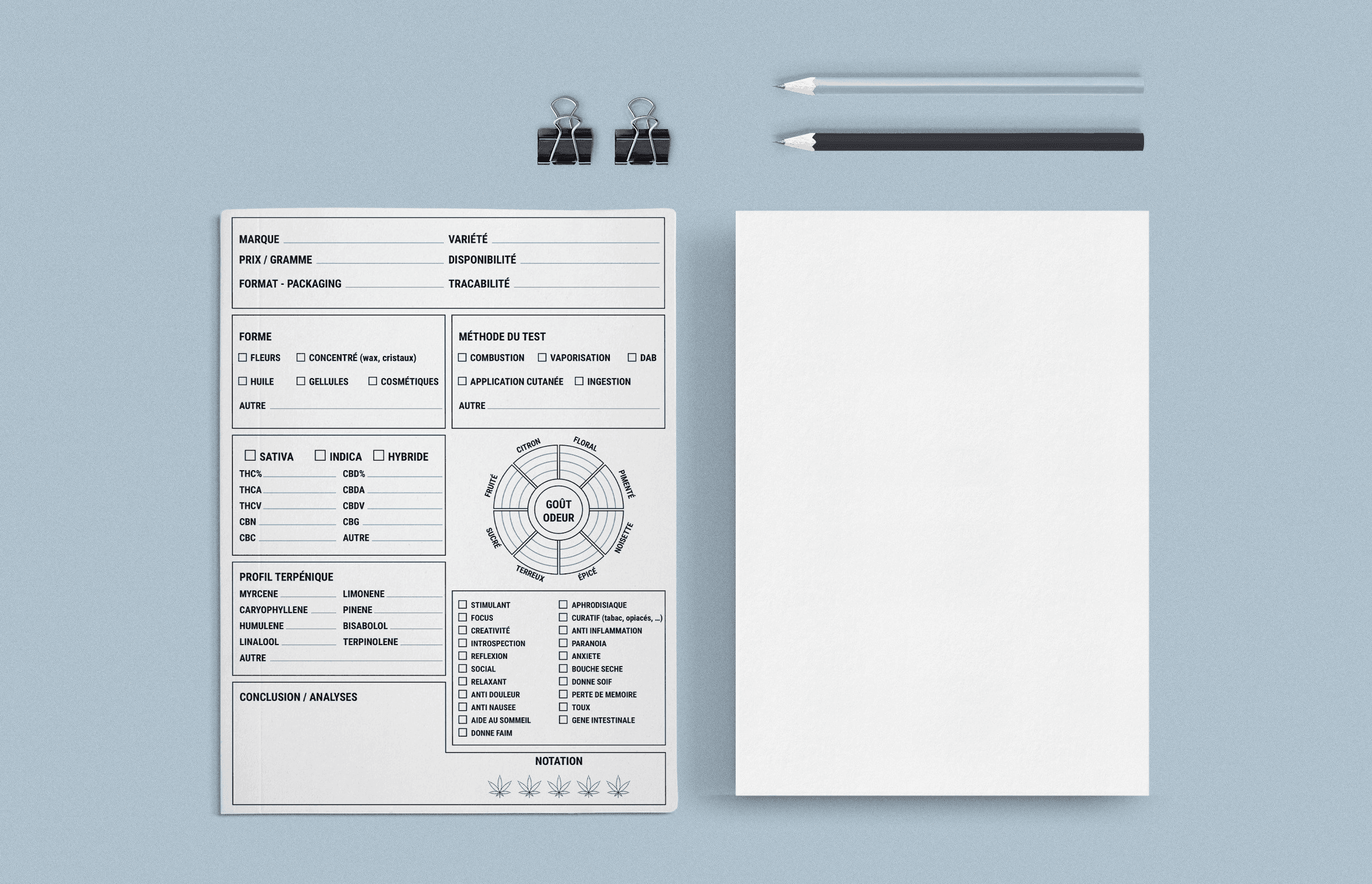 a white paper, pencil, and a piece of paper on a blue surface