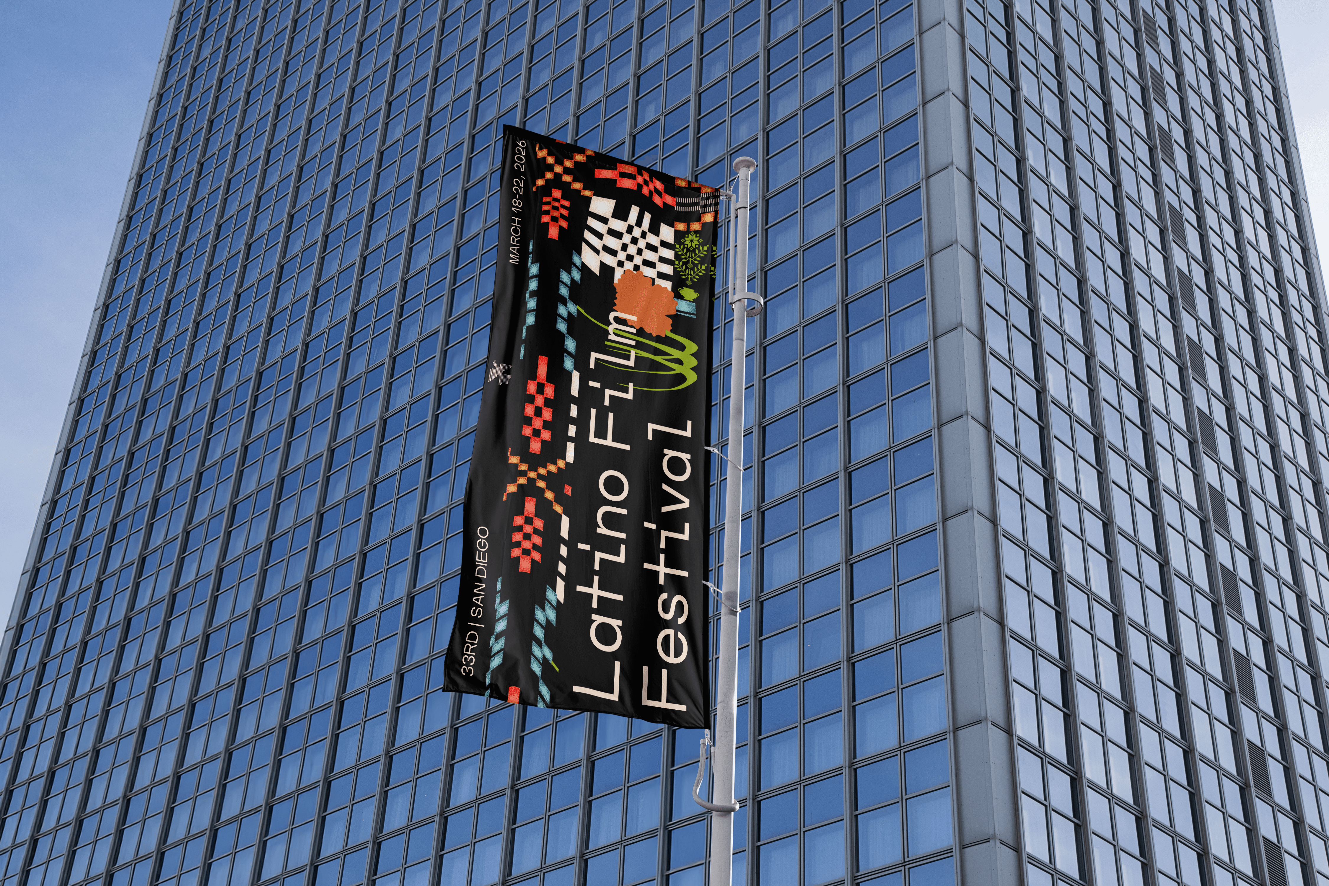 Flag in front of a glass office building.