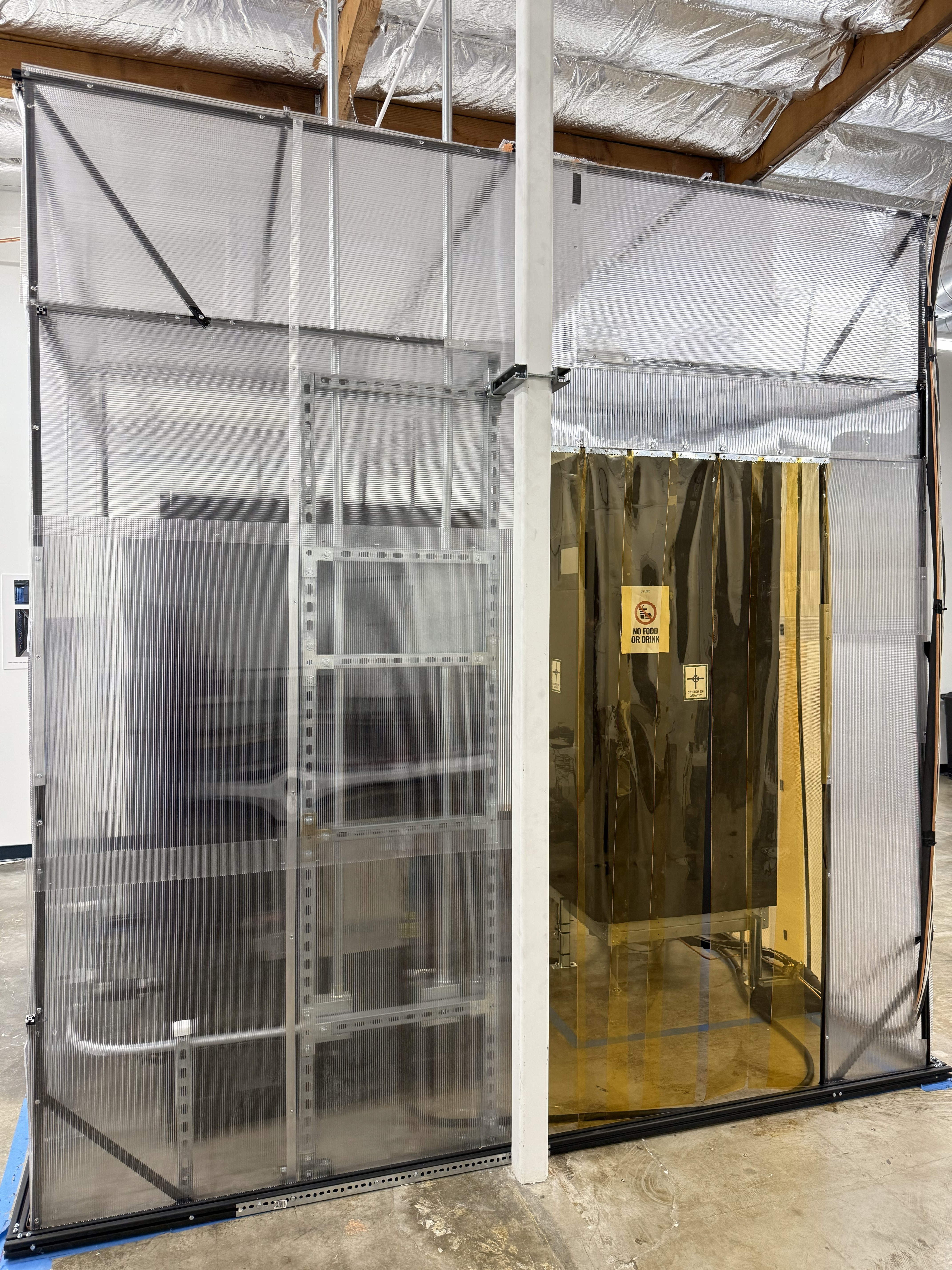 FLUIX experimental setup includes a lab containment featuring a bottom cold aisle flooded zone, and a top isolated hot air return plenum. Located within a warehouse setting.