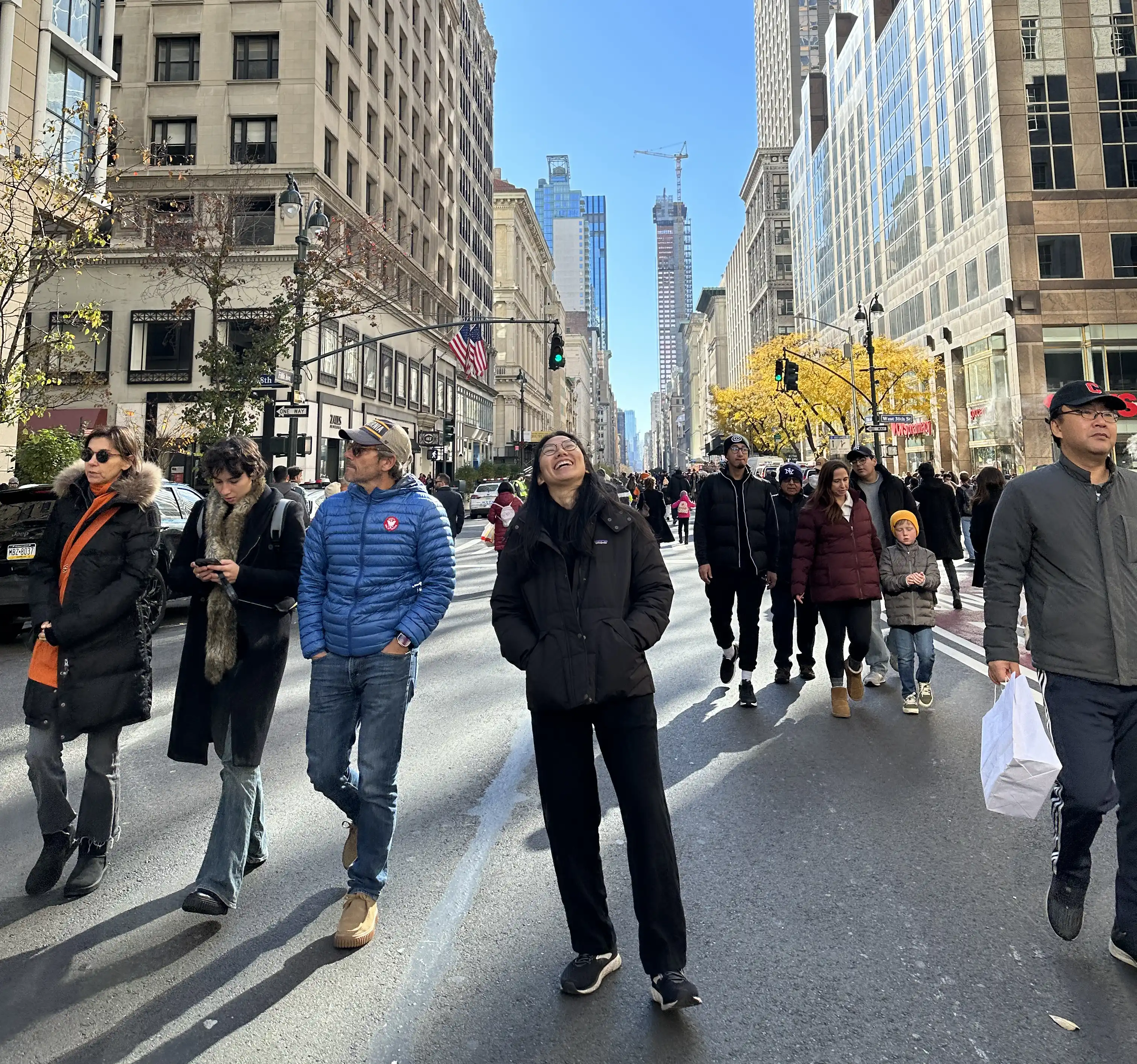 Abstract macro of a glass drop forming a black-and-white flower shape through light refraction on a soft gray background.