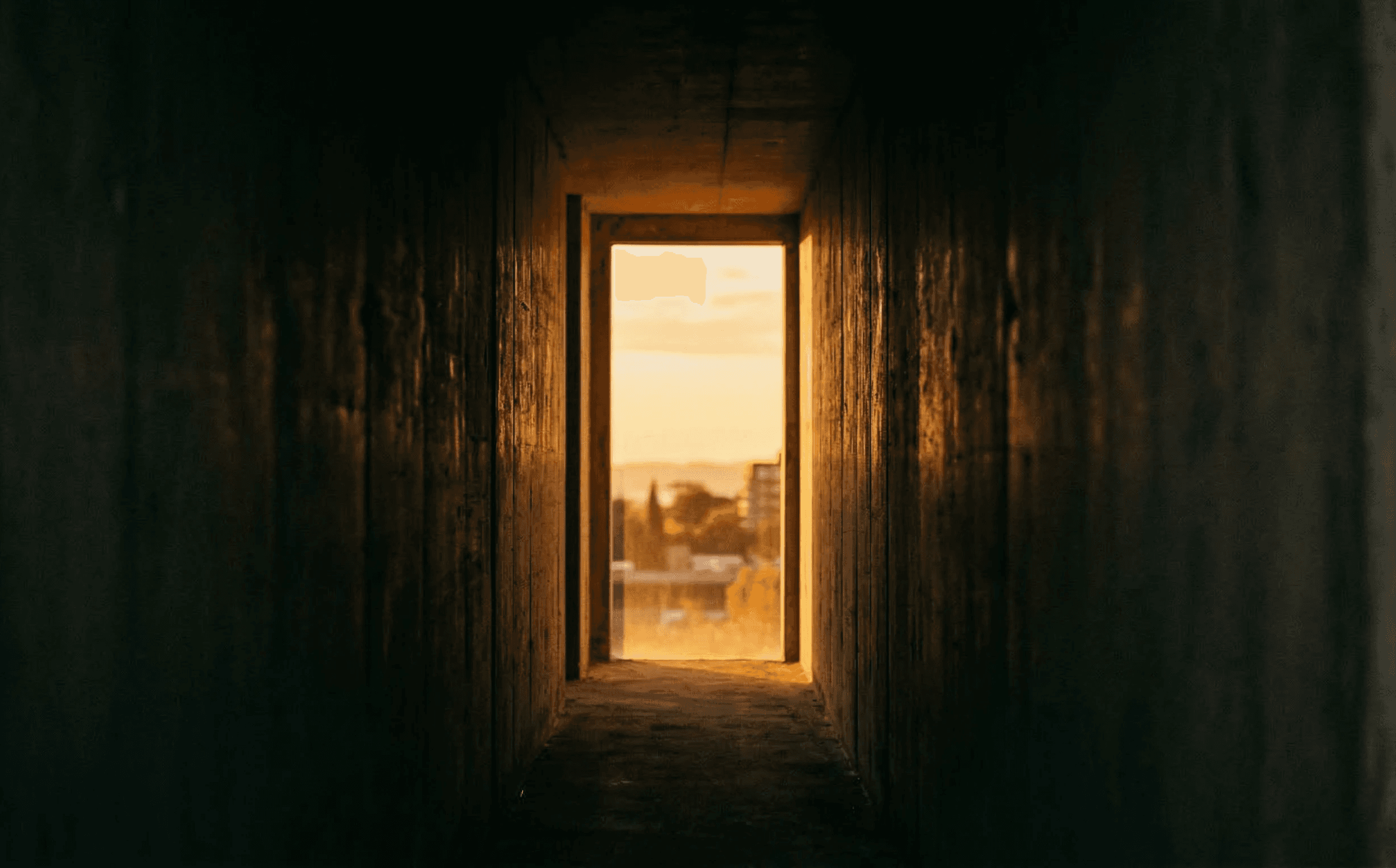 A close-up view of an industrial electric motor with visible metal casing and wiring, set against a blurred green backdrop, highlighting a heavy-duty machinery component.