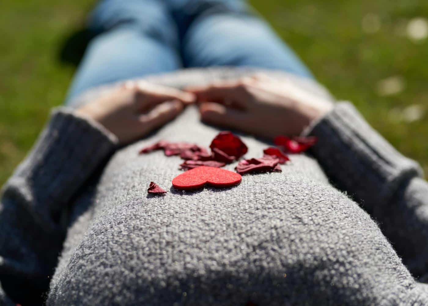 Resting heart rate and health - Woman lying down with paper hearts on her chest