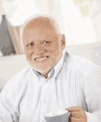 old man holding a cup of tea looking at the camera
