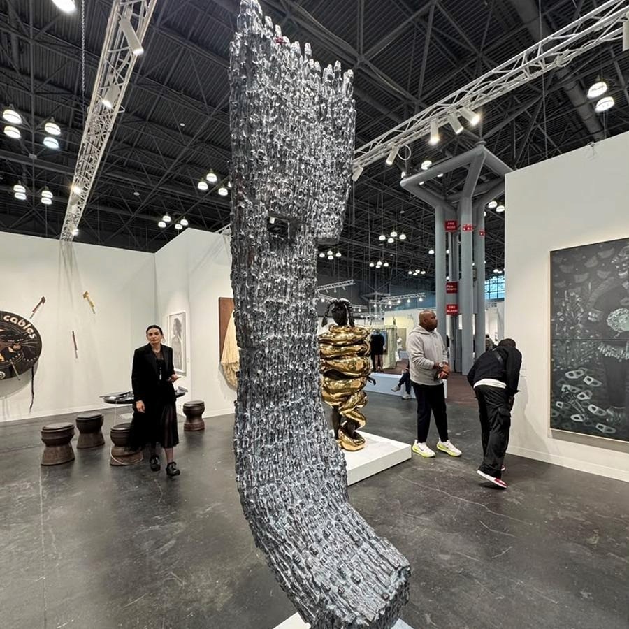 Dominique Zinkpè’s Poésie Humaine (2021), a bronze nearly two metres tall, cast from carved wooden figures that cluster into a single form.&nbsp; Courtesy the artist and Southern Guild