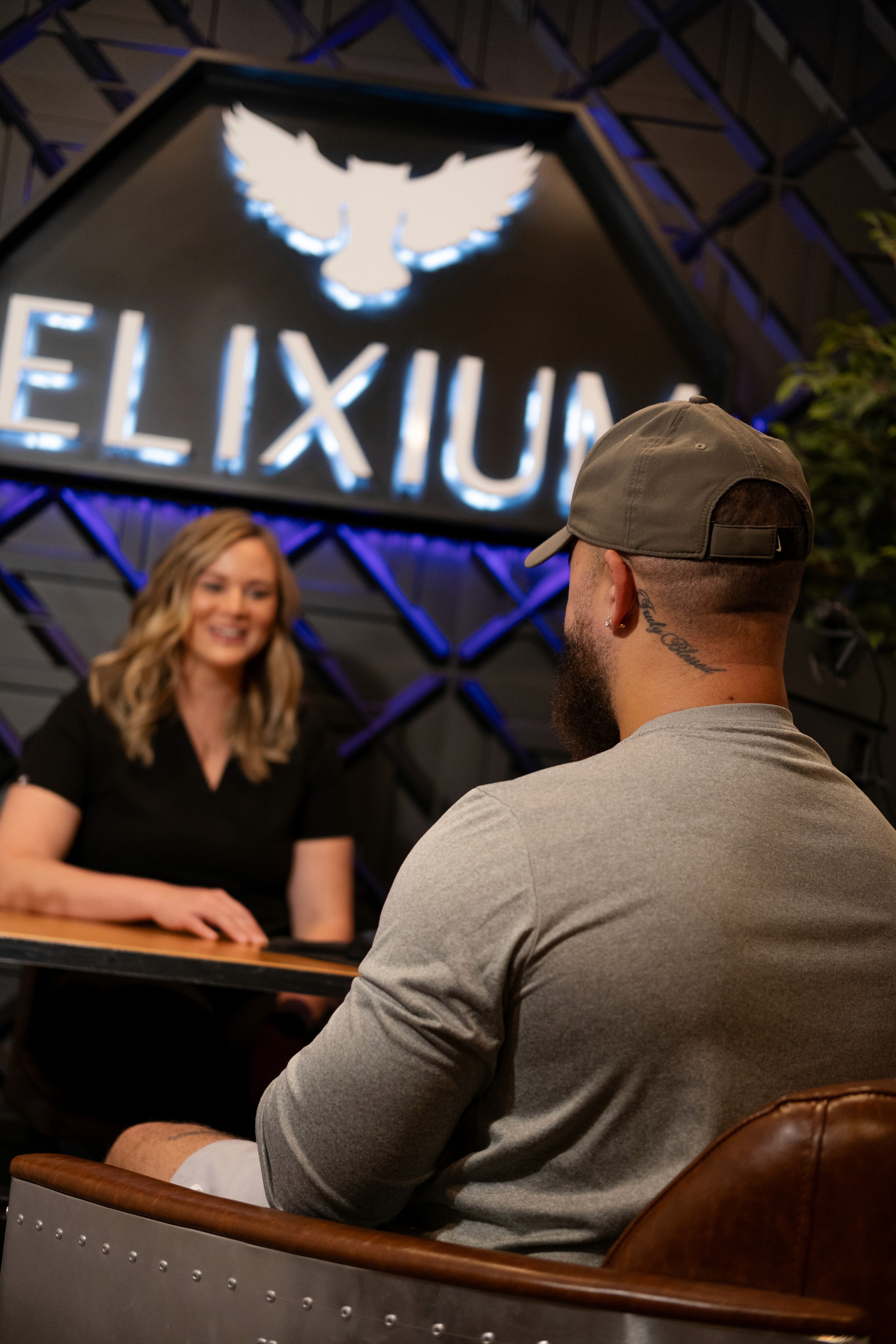 a staff member from Elixium Health talking to a person