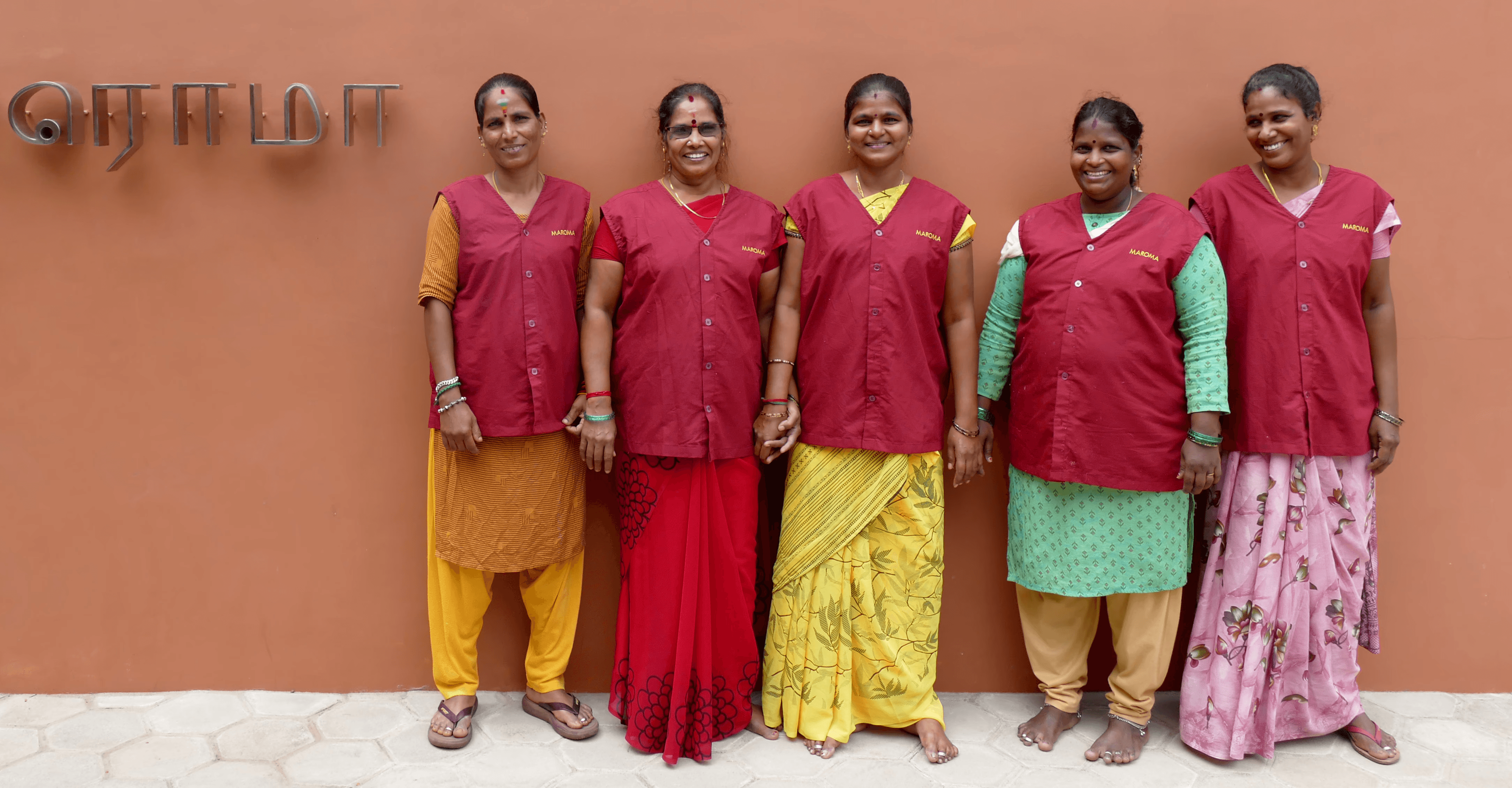 A woman lying down on a soft surface with her eyes closed, bathed in warm sunlight filtering through leaves. Her face has a natural glow, reflecting relaxation and tranquility in a serene spa-like setting.