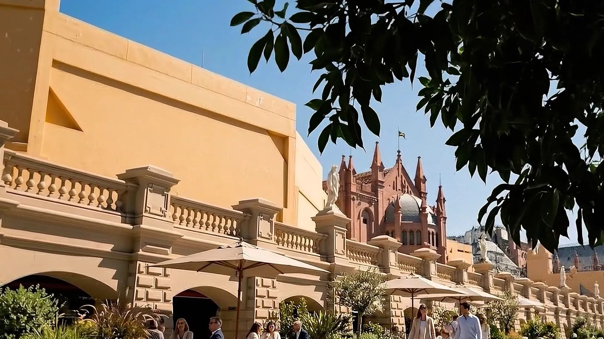 Façade of OH! Buenos Aires in the sun, with people walking among umbrellas
