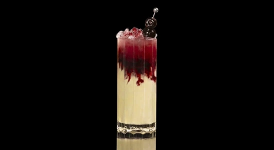 A closeup of a Smashed Ice Daiquiri drink against a dark background.
