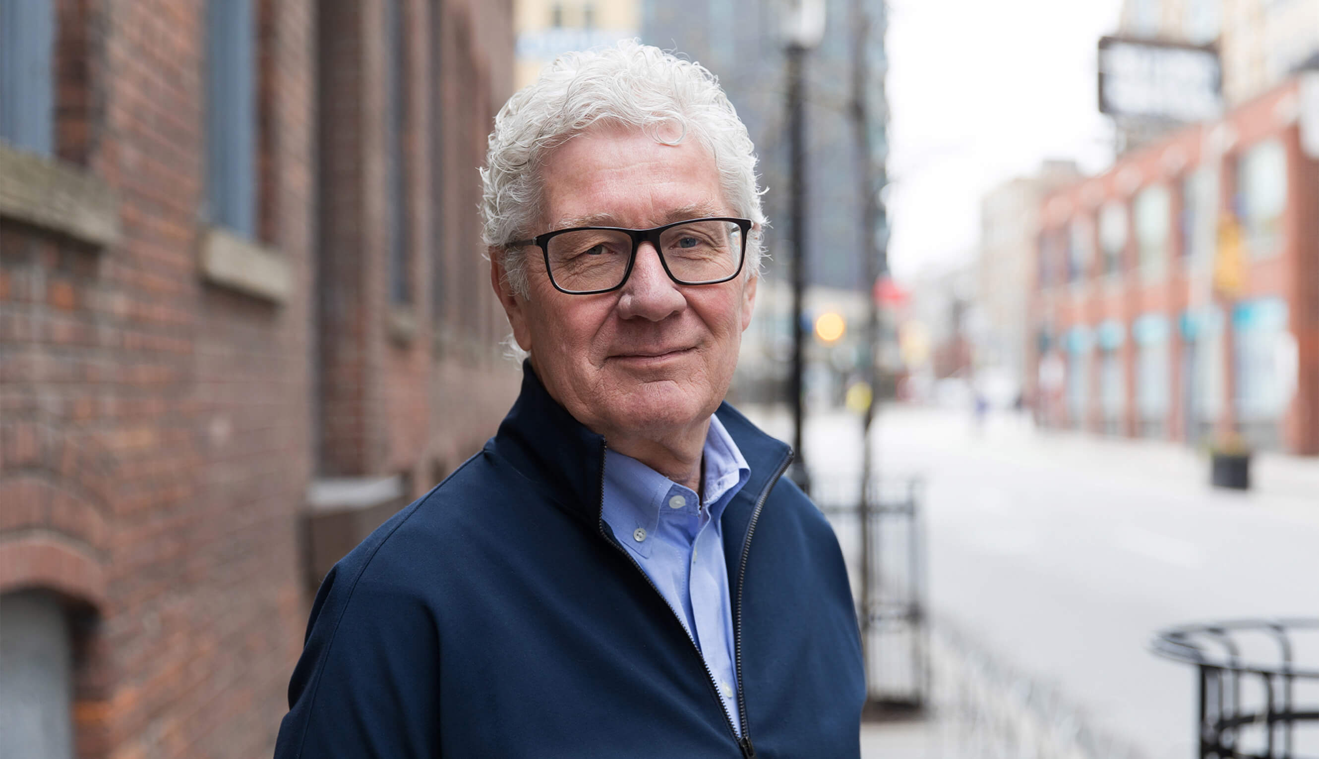 Similing portrait of Donald Schmitt, principal of Diamond Schmitt Architects.