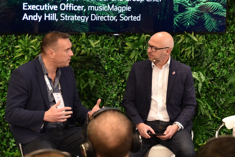 Two speakers in discussion on stage at retail event