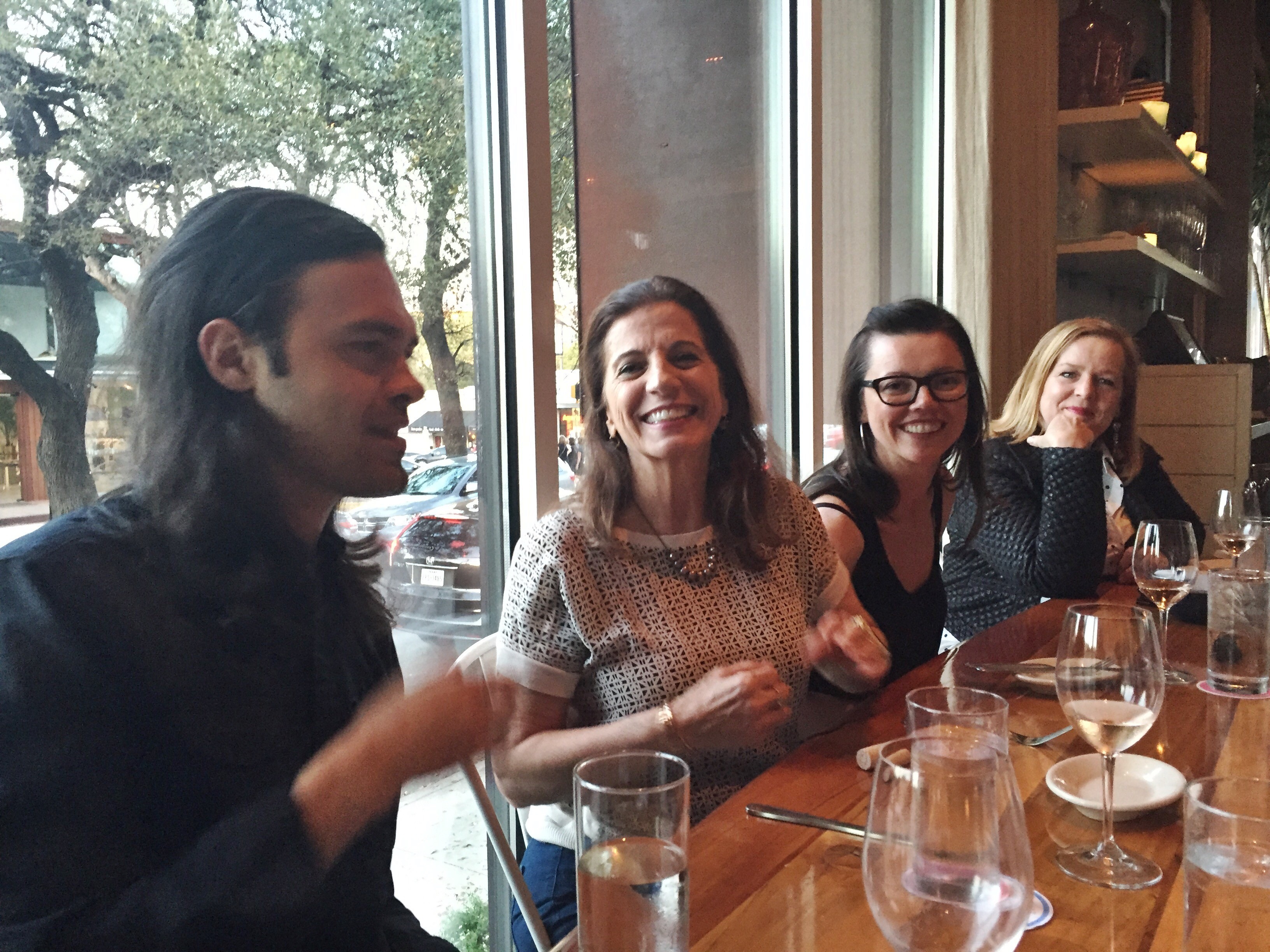 four people sitting at a restaurant table