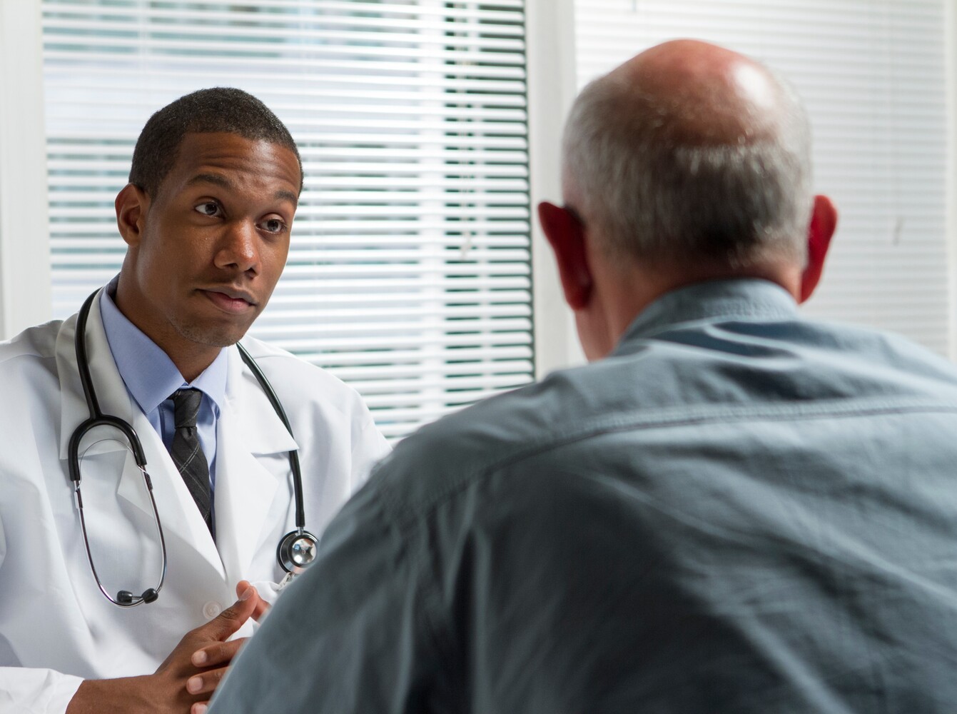 older man discussing if a prescription weight loss pill is right for him with his doctor