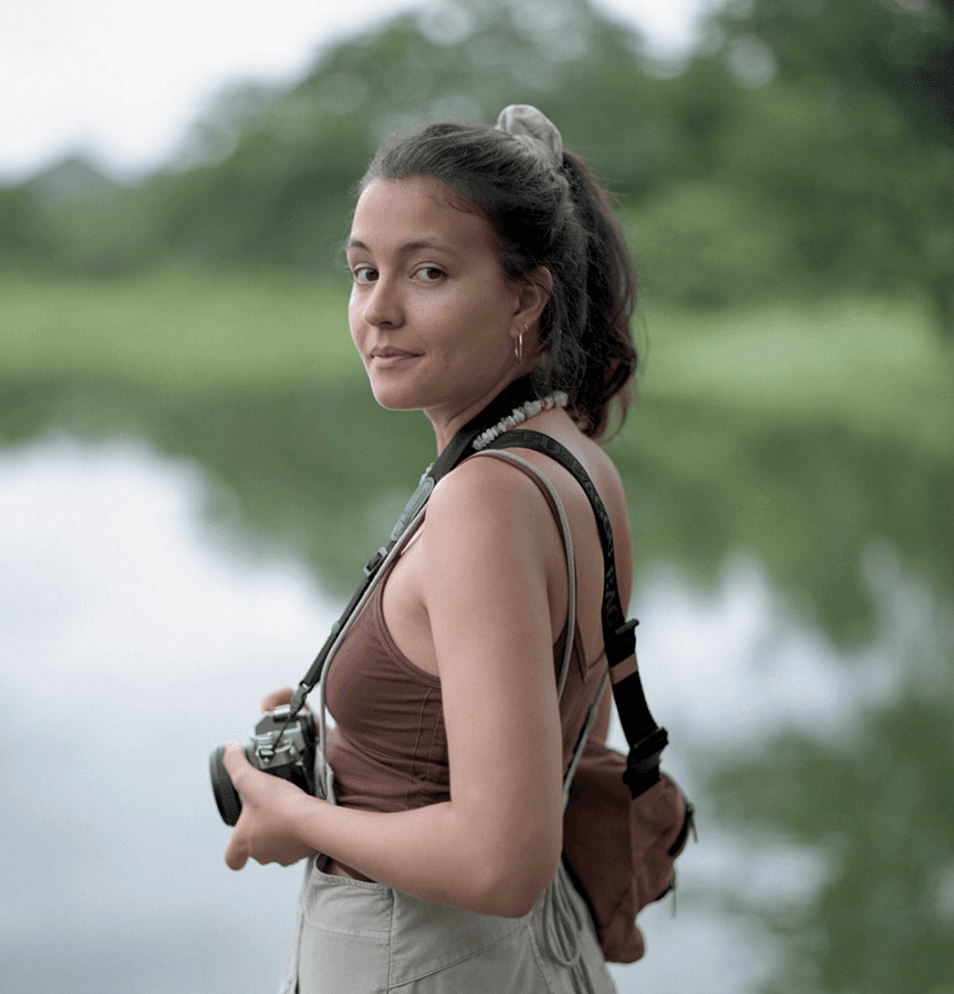 latin woman holding camera in the nature