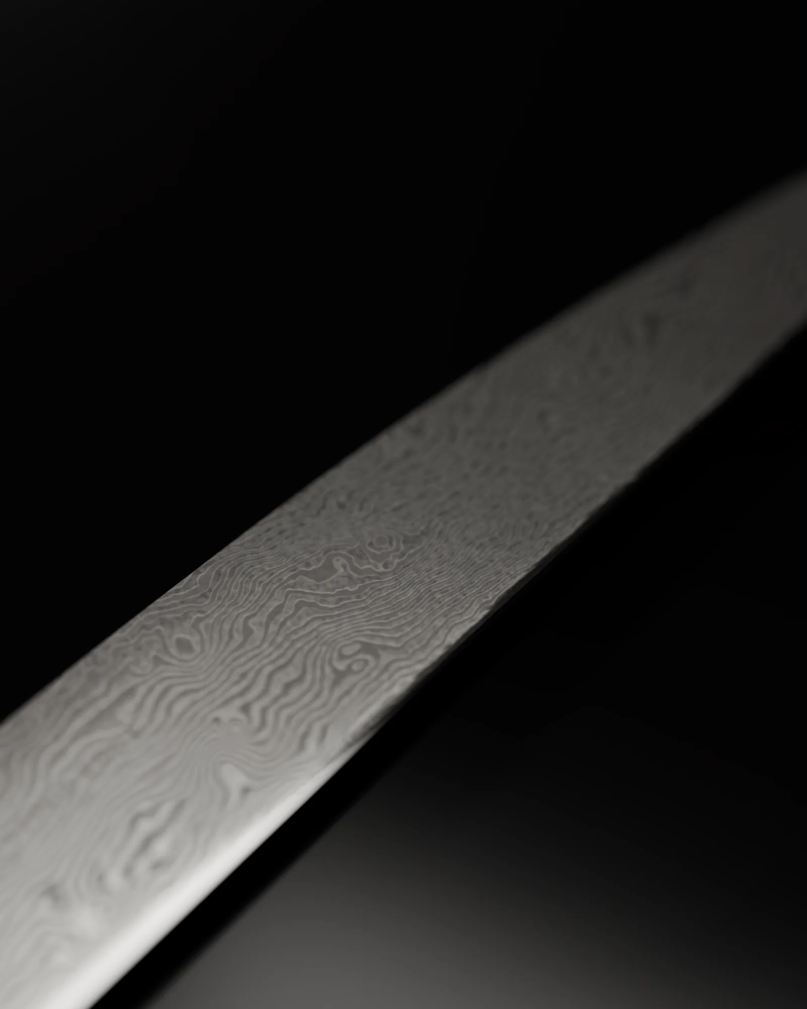 Damascus layers along the sujihiki's blade