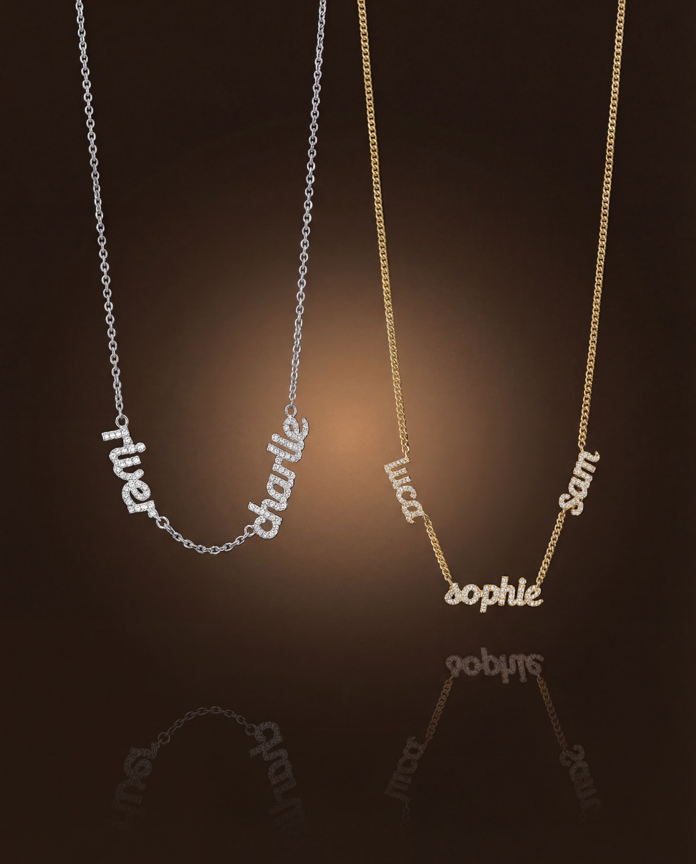 Vedder & Vedder — Silver and gold personalized necklaces against a dark reflective background.