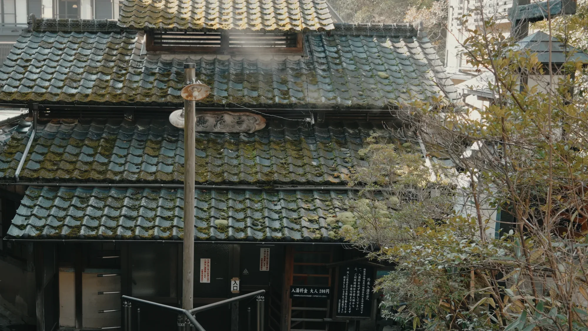Tiled roofs at Kurokawa Onsen with a power pole standing among them