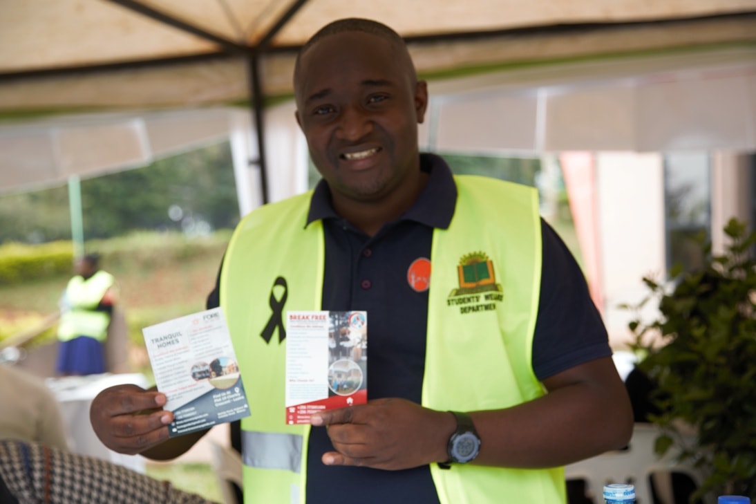 man in black suit jacket holding white ceramic mug